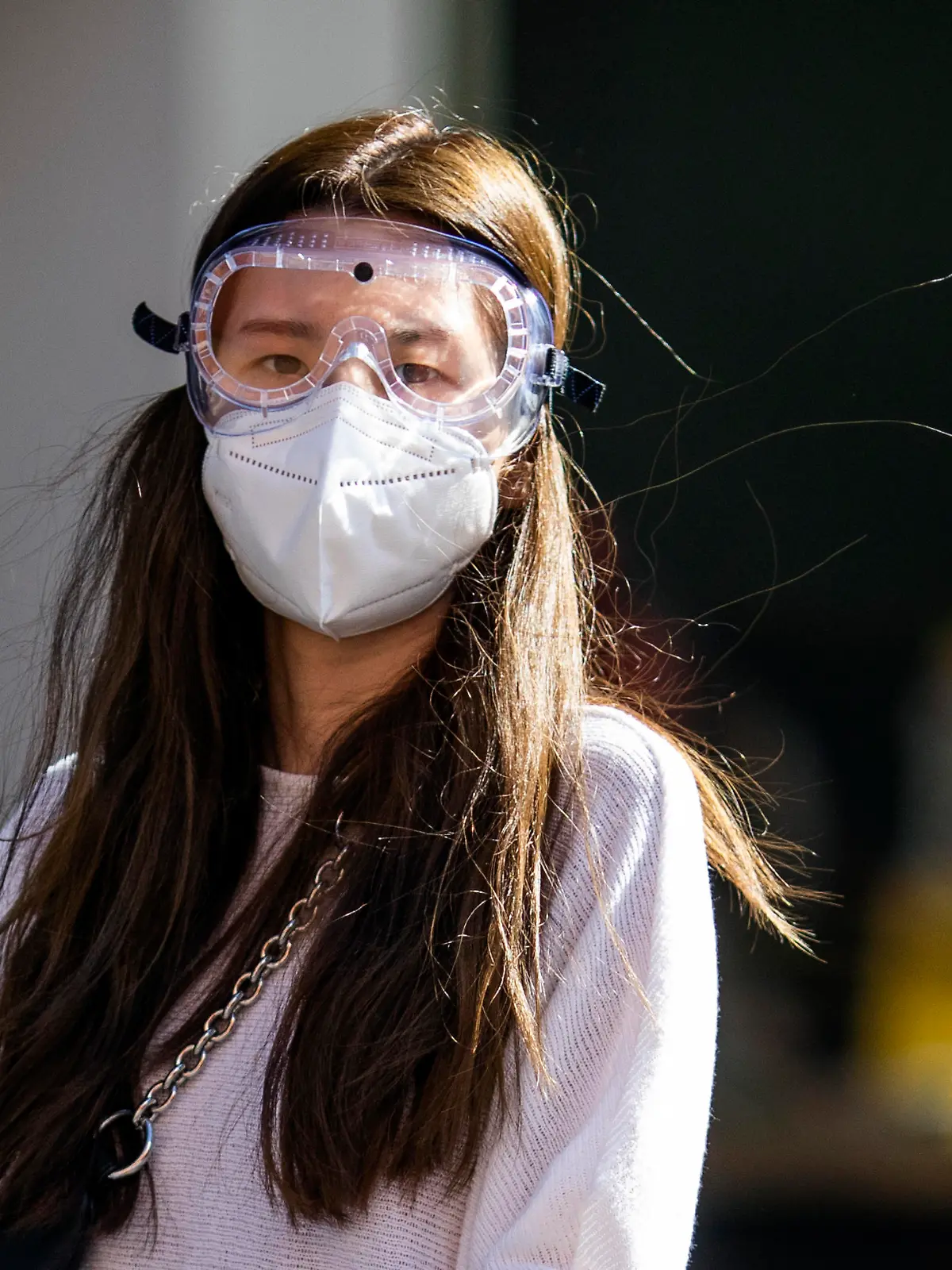 LONDON, ENGLAND  - APRIL 22: A woman wearing a face mask and goggles walks near Elephant and Castle underground station on April 22, 2020 in London, England. The British government has extended the lockdown restrictions first introduced on March 23 that are meant to slow the spread of COVID-19. (Photo by Dan Kitwood/Getty Images)