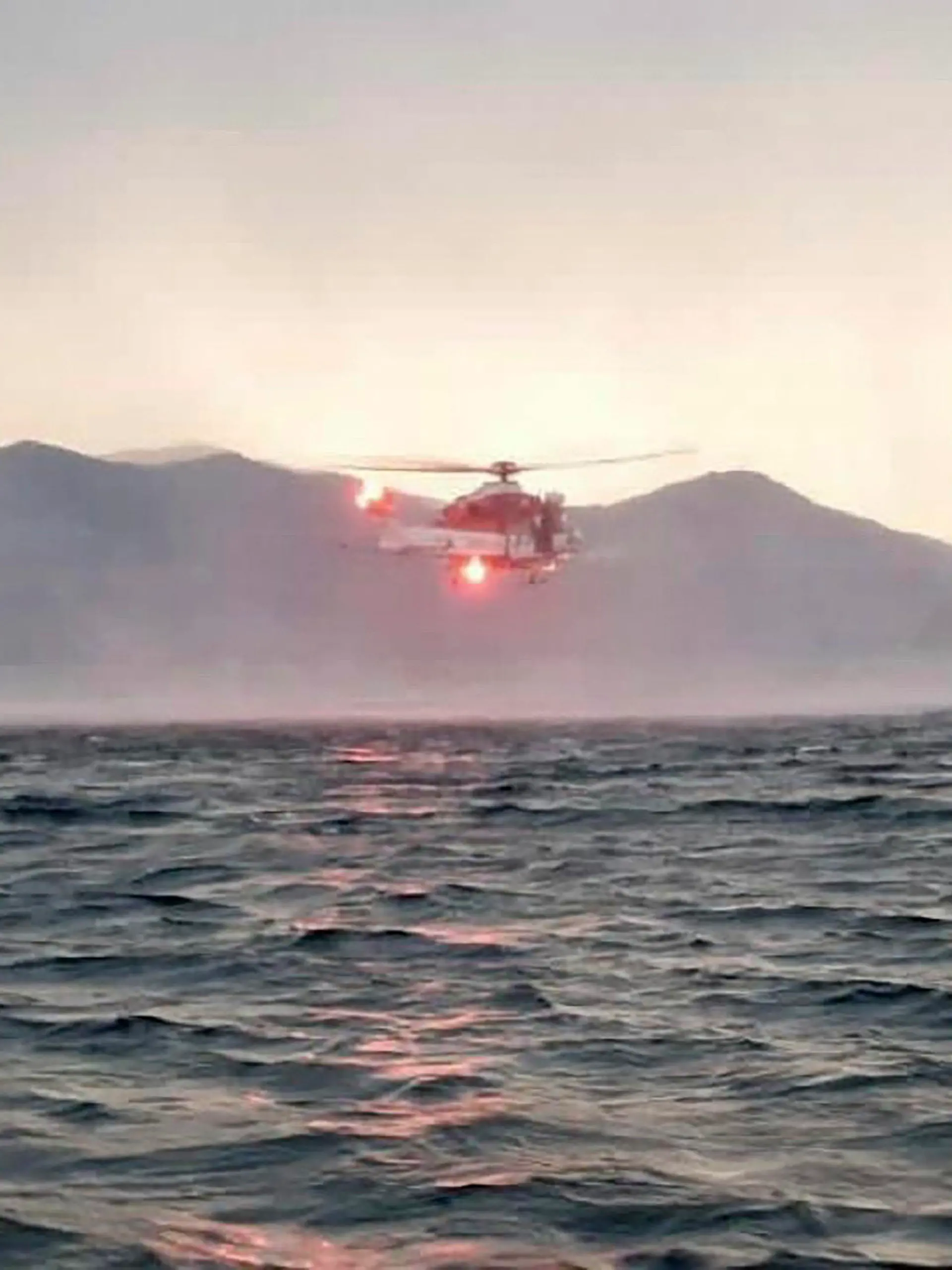 HANDOUT - 28.05.2023, Italien, Lago Maggiore: Dieses von der italienischen Feuerwehr veröffentlichten Bild zeigt einen Hubschrauber bei der Suche nach Vermissten, nachdem ein Touristen-Boot in einem Sturm auf dem italienischen Lago Maggiore gekentert ist. Bei einem Bootsunglück auf dem Lago Maggiore in Norditalien sind mehrere Menschen als vermisst gemeldet worden. Wie die italienischen Nachrichtenagenturen Ansa und Adnkronos berichteten, kam ein Mensch bei dem Vorfall am Sonntagabend ums Leben. Foto: Uncredited/Vigili del Fuoco/AP/dpa - ACHTUNG: Nur zur redaktionellen Verwendung bis zum 11.06.2023 im Zusammenhang mit der aktuellen Berichterstattung und nur mit vollständiger Nennung des vorstehenden Credits +++ dpa-Bildfunk +++