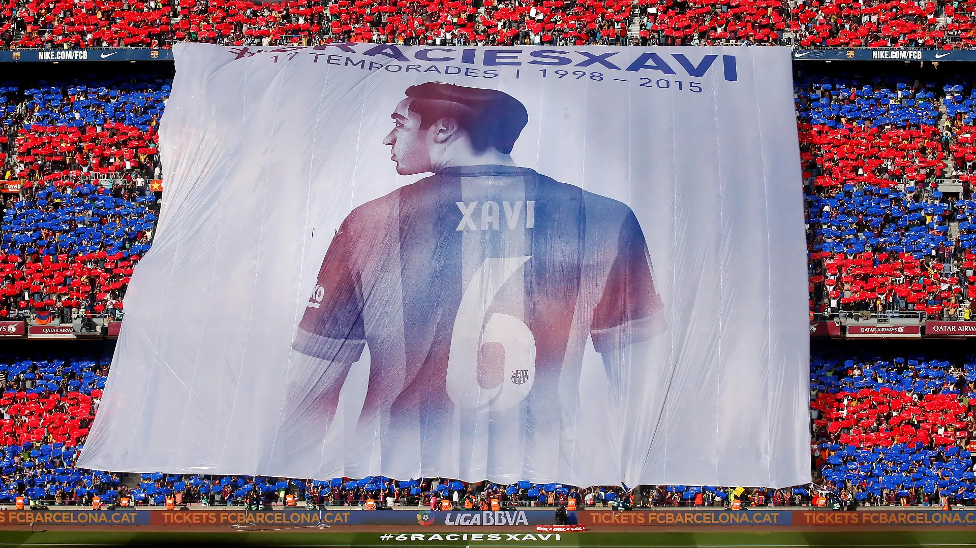 FILE PHOTO: Supporters display a giant banner of Barcelona's Xavi Hernandez during their Spanish first division soccer match against Deportivo de la Coruna at Camp Nou stadium in Barcelona, Spain, May 23, 2015. Xavi announced on Thursday his retirement from Barcelona at the end of the current season. He will play next season at Al Sadd in Qatar. The banner reads: "Thanks Xavi, 17 seasons 1998-2015". REUTERS/Albert Gea/File Photo