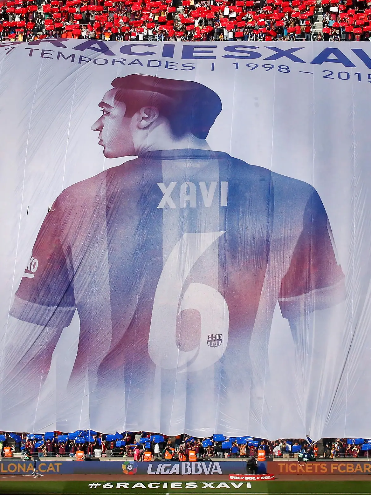 FILE PHOTO: Supporters display a giant banner of Barcelona's Xavi Hernandez during their Spanish first division soccer match against Deportivo de la Coruna at Camp Nou stadium in Barcelona, Spain, May 23, 2015. Xavi announced on Thursday his retirement from Barcelona at the end of the current season. He will play next season at Al Sadd in Qatar. The banner reads: "Thanks Xavi, 17 seasons 1998-2015". REUTERS/Albert Gea/File Photo