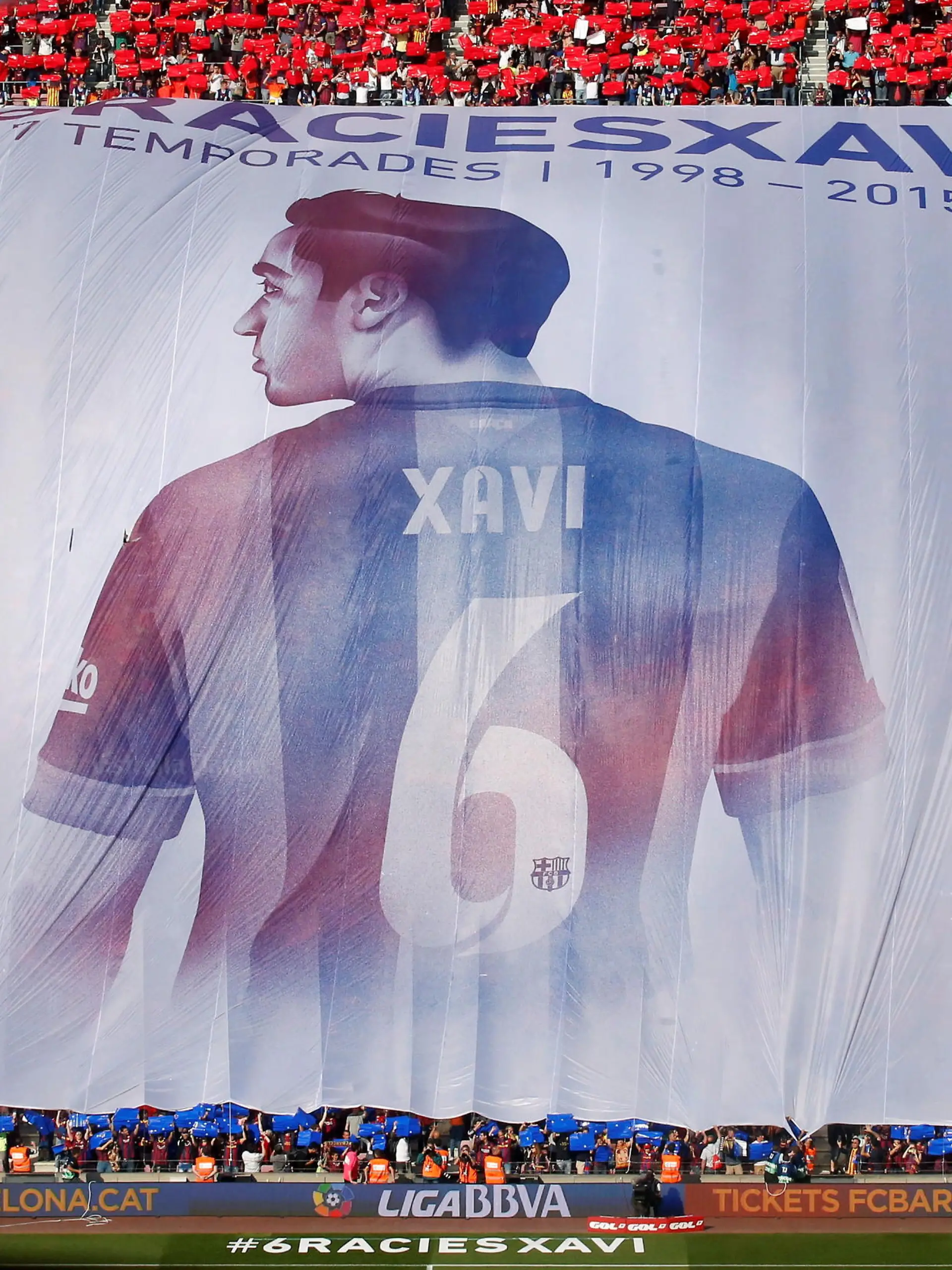 FILE PHOTO: Supporters display a giant banner of Barcelona's Xavi Hernandez during their Spanish first division soccer match against Deportivo de la Coruna at Camp Nou stadium in Barcelona, Spain, May 23, 2015. Xavi announced on Thursday his retirement from Barcelona at the end of the current season. He will play next season at Al Sadd in Qatar. The banner reads: "Thanks Xavi, 17 seasons 1998-2015". REUTERS/Albert Gea/File Photo