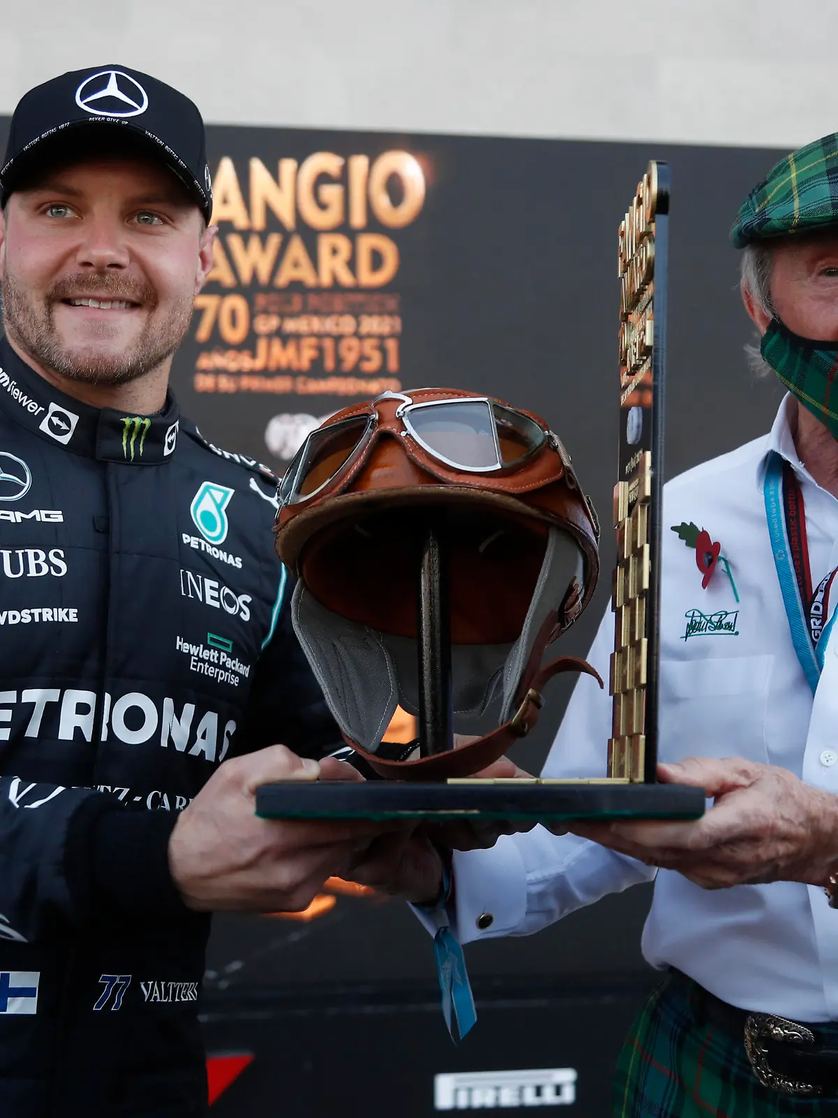 Formula One F1 - Mexico Grand Prix - Autodromo Hermanos Rodriguez, Mexico City, Mexico - November 6, 2021 Mercedes' Valtteri Bottas celebrates pole position with Jackie Stewart Pool via REUTERS/Francisco Guasco
