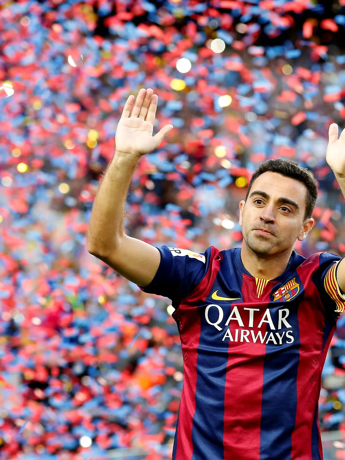 FILE PHOTO: Barcelona's Xavi Hernandez waves to supporters after their Spanish first division soccer match against Deportivo de la Coruna at Camp Nou stadium in Barcelona, Spain, May 23, 2015. REUTERS/Gustau Nacarino/File Photo