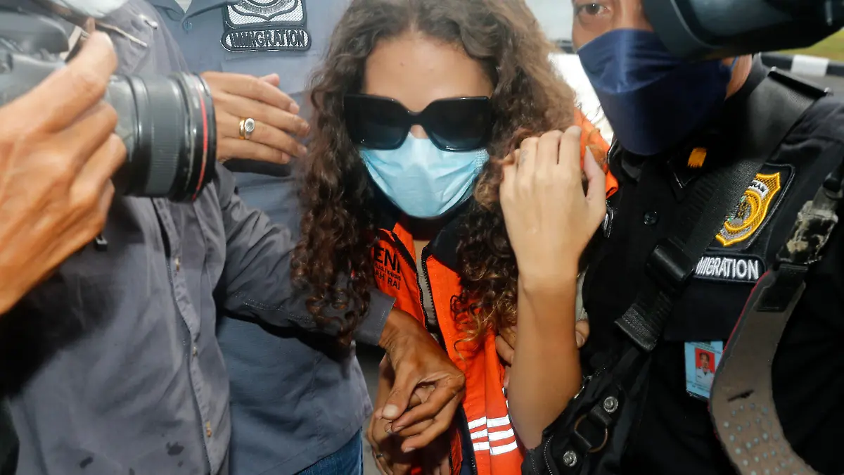 FILE - Heather Mack of Chicago, Ill., center, escorted by immigration officers to Immigration detention center in Jimbaran, Bali, Indonesia on Friday, Oct. 29, 2021. Mack, who served more than seven years in an Indonesian prison for killing her mother at a luxury resort in Bali has been indicted on federal murder conspiracy charges and taken into custody by FBI agents at O'Hare International Airport in Chicago on Wednesday Nov. 3, 2021. (AP Photo/Firdia Lisnawati, File)