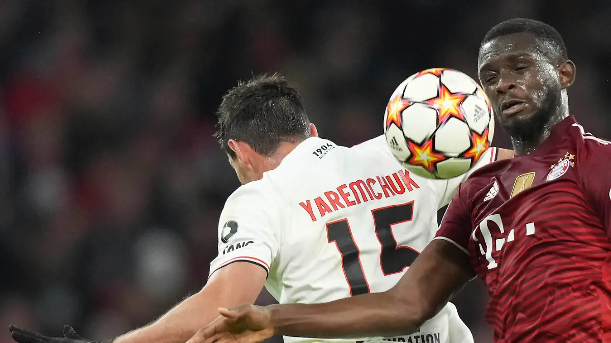 Bayern's Tanguy Nianzou and Benfica's Roman Yaremchuk challenge for the ball during the Champions League group E soccer match between Bayern Munich and Benfica Lisbon in Munich, Germany, Tuesday, Nov. 2, 2021.(AP Photo/Matthias Schrader)