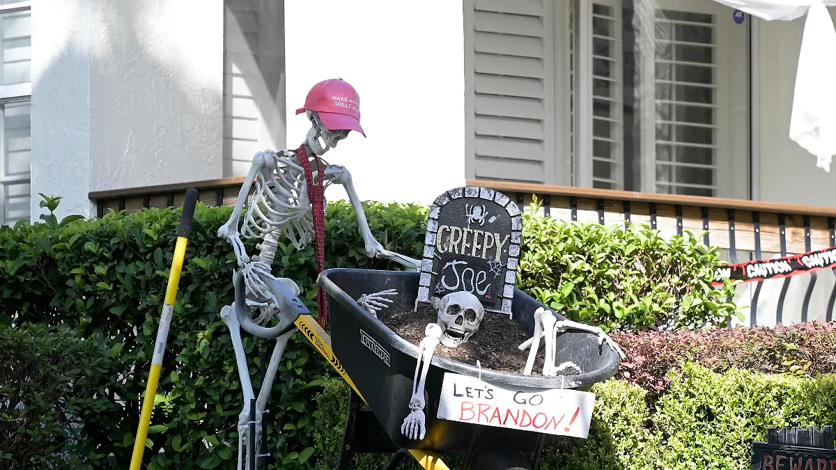 A Halloween display incorporating a Make America Great Again hat, a Creepy Joe headstone and a Let's Go Brandon sign is viewed outside a home during a new coronavirus pandemic, Wednesday, Oct. 27, 2021, in Orlando, Fla. (AP Photo/Phelan M. Ebenhack)