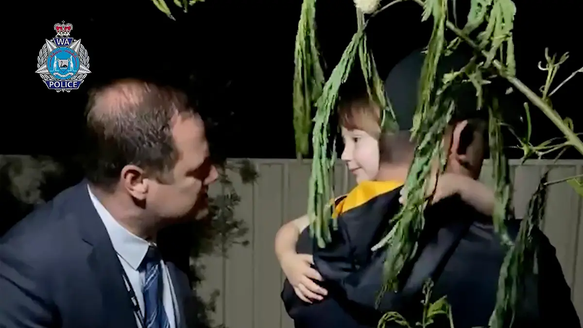 In this image made from a video released by Western Australia Police, a police officer carries  rescued girl Cleo Smith in Carnarvon, Australia Wednesday, Nov. 3, 2021. Police smashed their way into a suburban house on Wednesday and rescued the girl whose disappearance from her family's camping tent on Australia's remote west coast more than two weeks ago both horrified and captivated the nation. (Western Australia Police via AP)