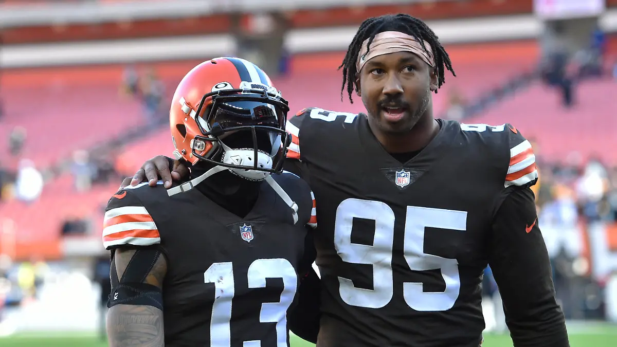 Cleveland Browns defensive end Myles Garrett (95) and wide receiver Odell Beckham Jr. (13) walk off the field after the Steelers defeated the Cleveland Browns 15-10 in an NFL football game, Sunday, Oct. 31, 2021, in Cleveland. (AP Photo/David Richard)