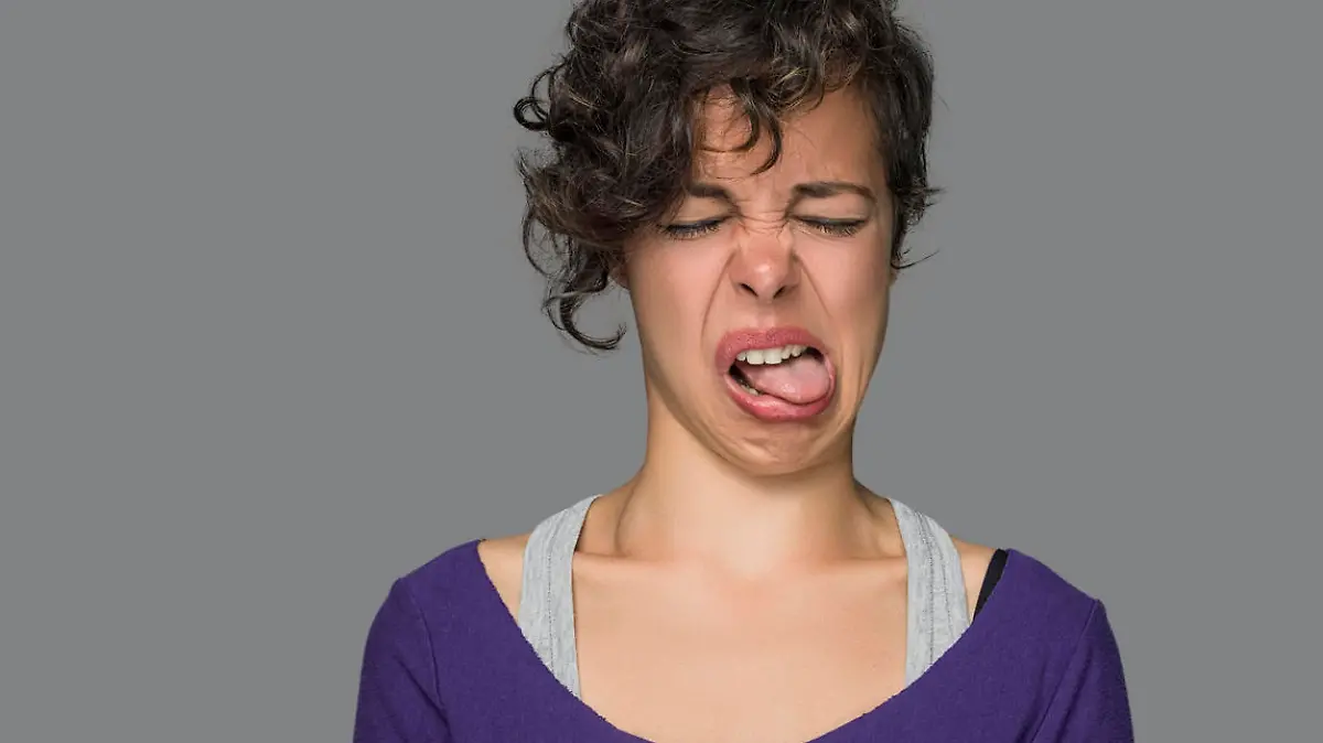 Disgusted Young Woman Sticking Out Tongue