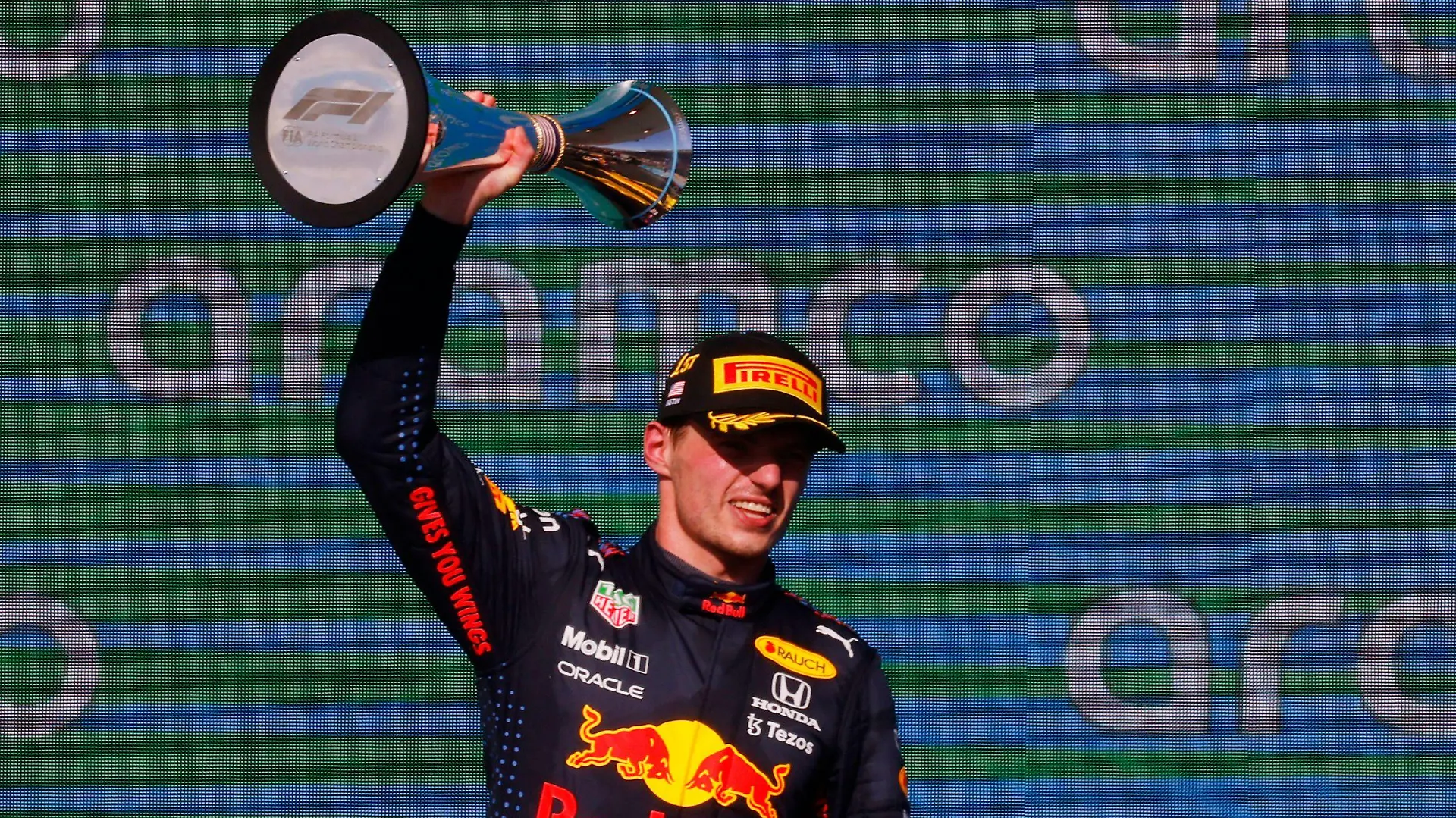 Formula One F1 - United States Grand Prix - Circuit of the Americas, Austin, Texas, U.S. - October 24, 2021 Red Bull's Max Verstappen celebrates on the podium with the trophy after winning the race REUTERS/Brian Snyder