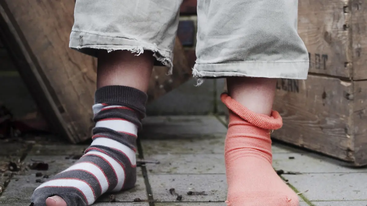 ARCHIV - Ein zehn Jahre altes Mädchen steht in abgetragener Kleidung, ohne Schuhe und mit verschiedenen Socken in einem Hinterhof (Archivfoto vom 21.03.2008, Illustration zum Thema Armut). In Deutschlands einziger Vesperkirche, in Mannheim, bekommen bedürftige Kinder ein warmes Essen, Spiele und Nachmittagsbetreuung. Foto: Christian Hager (Zu dpa-lsw KORR "Mit 2,50 Euro am Tag, Hartz IV wird schwierig für Kinder" vom 02.11.2009) +++(c) dpa - Bildfunk+++
