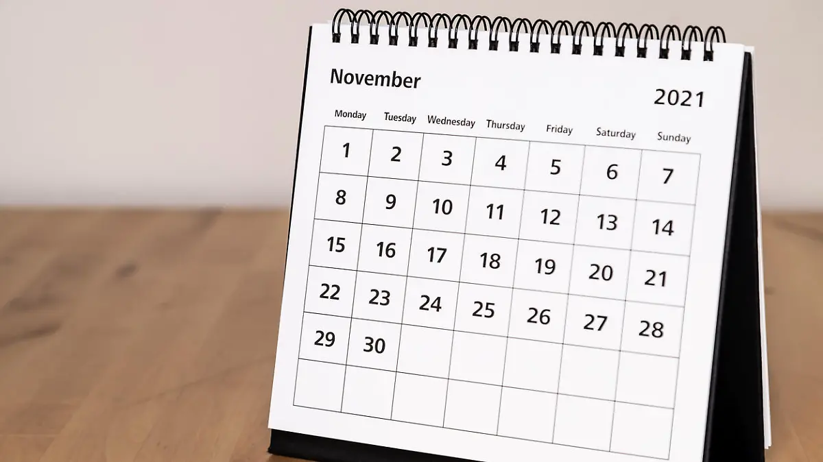 Month page: November in 2021 paper calendar on the wooden table