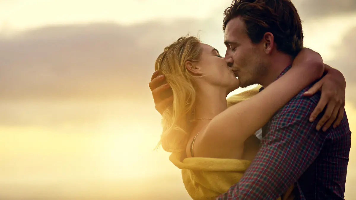 Shot of a romantic young couple sharing a passionate kiss at sunset