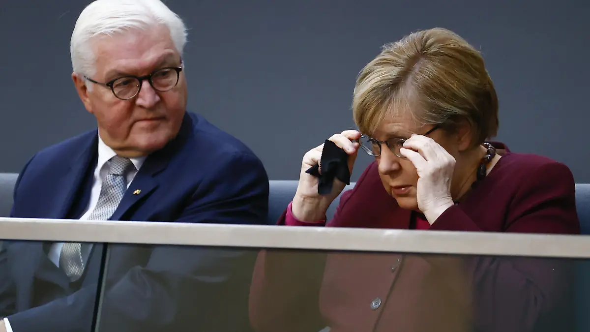 BERLIN, GERMANY - OCTOBER 26: German President Frank-Walter Steinmeier and German Chancellor Angela Merkel sit on the tribune during the first plenary session of Germany's new parliament at the Bundestag in Berlin, on October 26, 2021. Abdulhamid Hosbas / Anadolu Agency