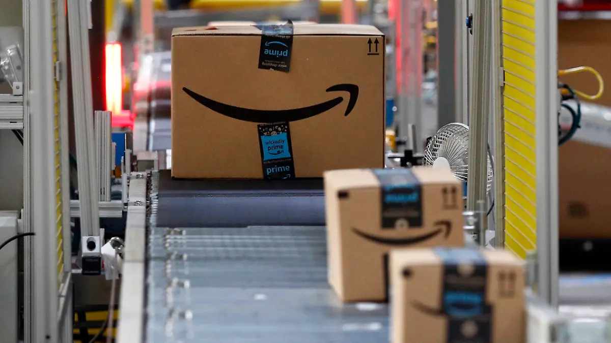 FILE - In this Aug. 3, 2017, file photo, packages pass through a scanner at an Amazon fulfillment center in Baltimore. Amazon Shipping, which allows sellers to ship Amazon orders or products sold on other sites, has relaunched, the company confirmed Friday, Aug. 18, 2023. Businesses must sell on Amazon to be eligible for the service, according to a company spokesperson. (AP Photo/Patrick Semansky, File)