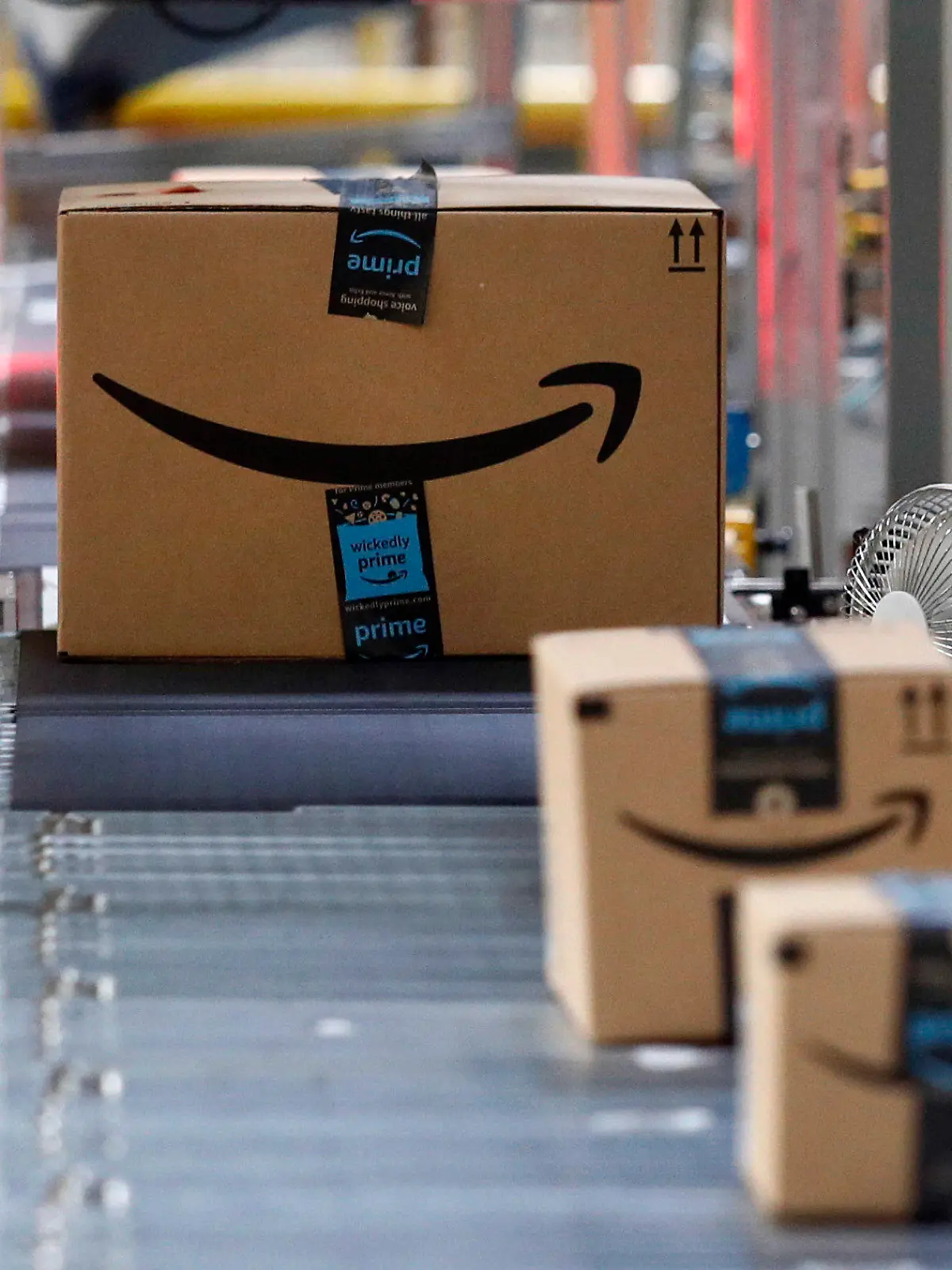 FILE - In this Aug. 3, 2017, file photo, packages pass through a scanner at an Amazon fulfillment center in Baltimore. Amazon Shipping, which allows sellers to ship Amazon orders or products sold on other sites, has relaunched, the company confirmed Friday, Aug. 18, 2023. Businesses must sell on Amazon to be eligible for the service, according to a company spokesperson. (AP Photo/Patrick Semansky, File)