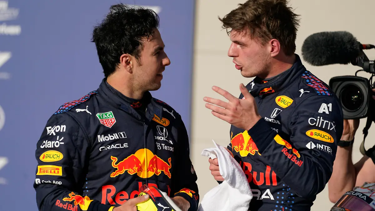 Red Bull driver Max Verstappen, right, of the Netherlands, and Red Bull driver Sergio Perez, of Mexico, talk after qualifications for the Formula One U.S. Grand Prix auto race at the Circuit of the Americas, Saturday, Oct. 23, 2021, in Austin, Texas. Verstappen won the pole and Perez will start third. (AP Photo/Darron Cummings)