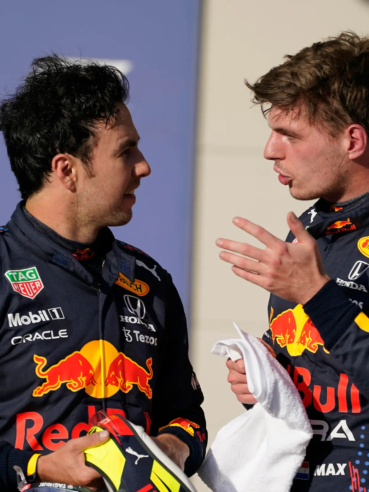 Red Bull driver Max Verstappen, right, of the Netherlands, and Red Bull driver Sergio Perez, of Mexico, talk after qualifications for the Formula One U.S. Grand Prix auto race at the Circuit of the Americas, Saturday, Oct. 23, 2021, in Austin, Texas. Verstappen won the pole and Perez will start third. (AP Photo/Darron Cummings)