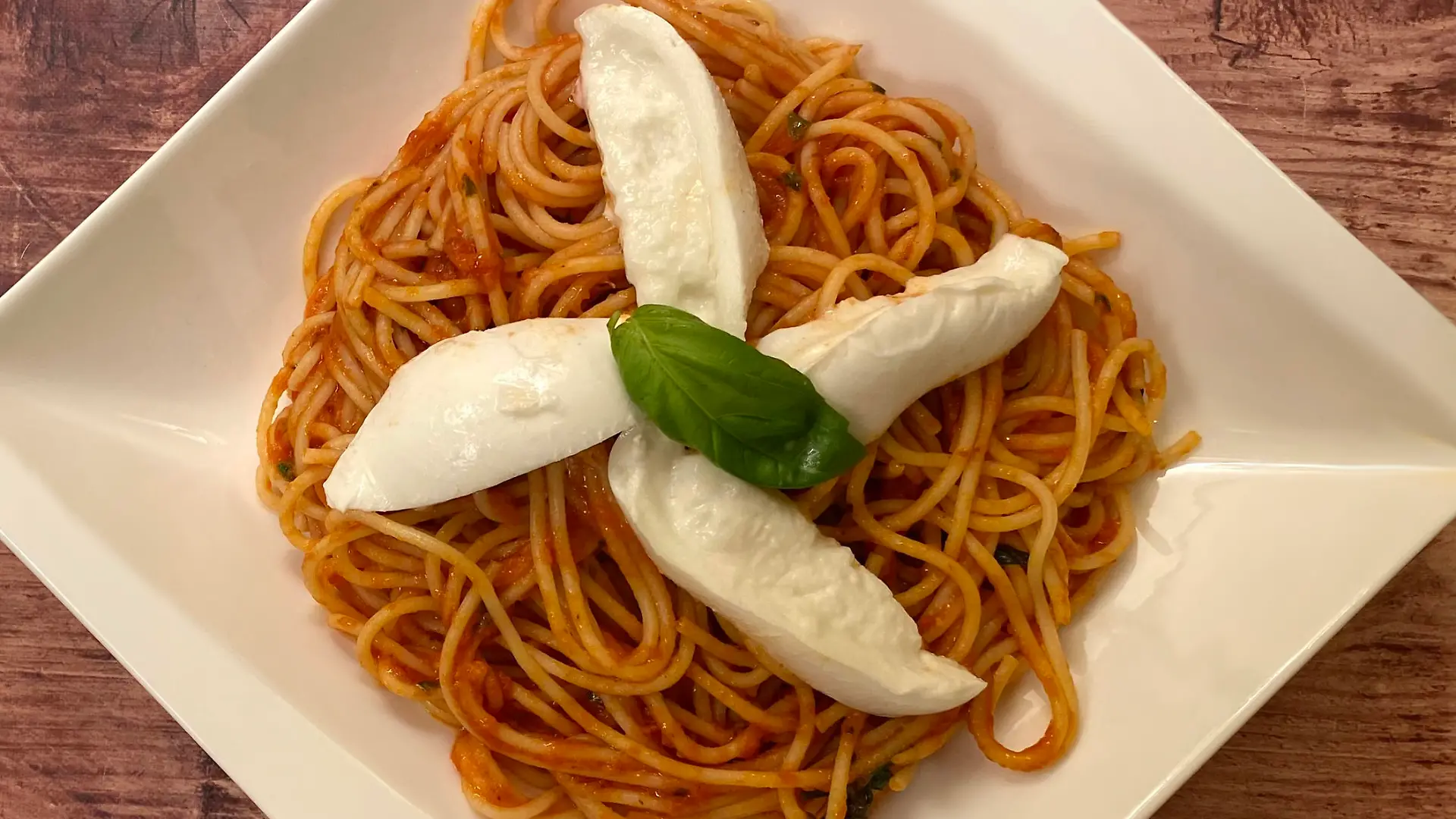 Spaghetti pasta with tomato sauce and basil.