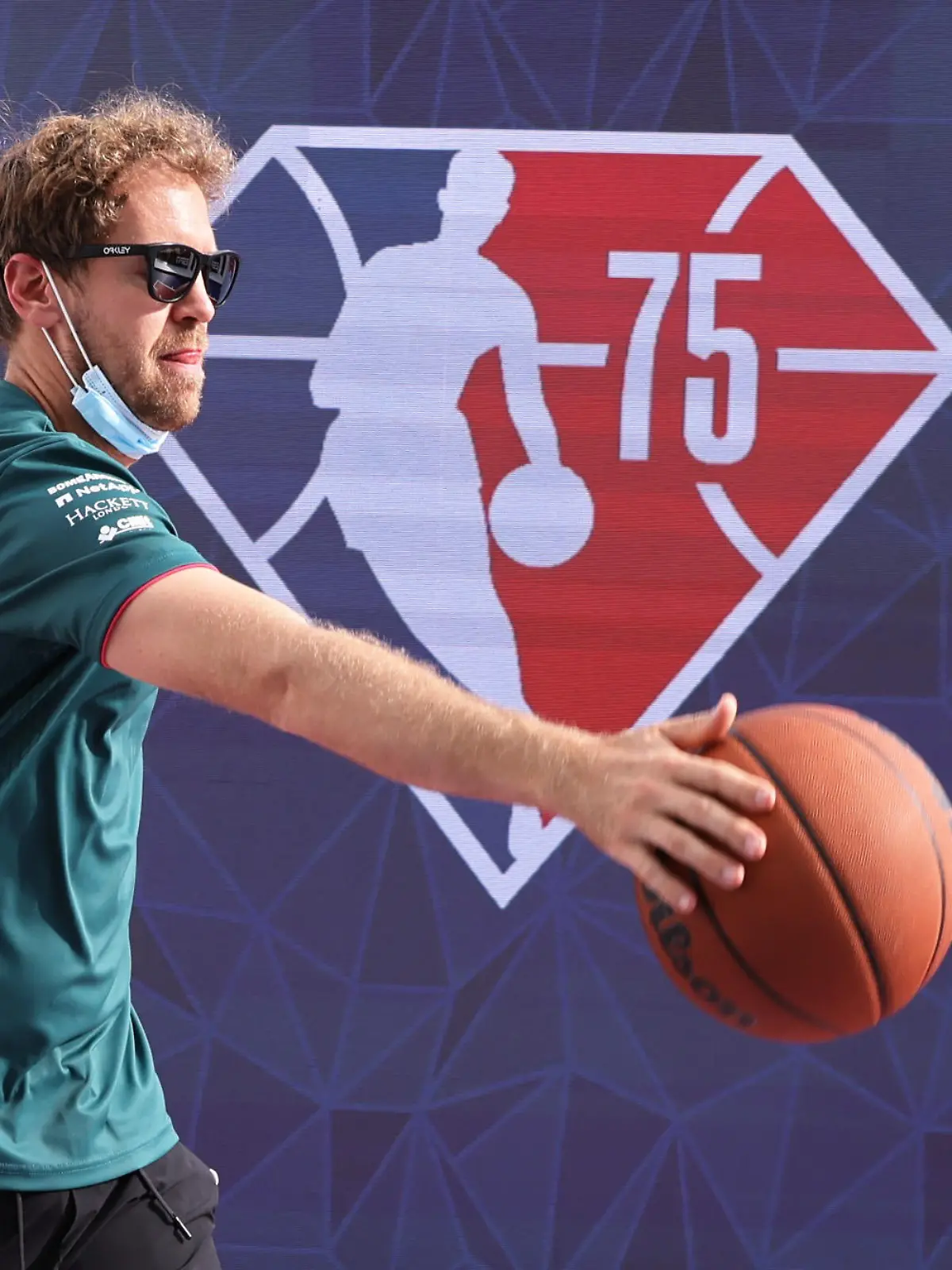 Formula One F1 - United States Grand Prix - Circuit of the Americas, Austin, Texas, U.S. - October 21, 2021 Aston Martin's Sebastian Vettel plays basketball in the paddock ahead of the Grand Prix REUTERS/Mike Blake