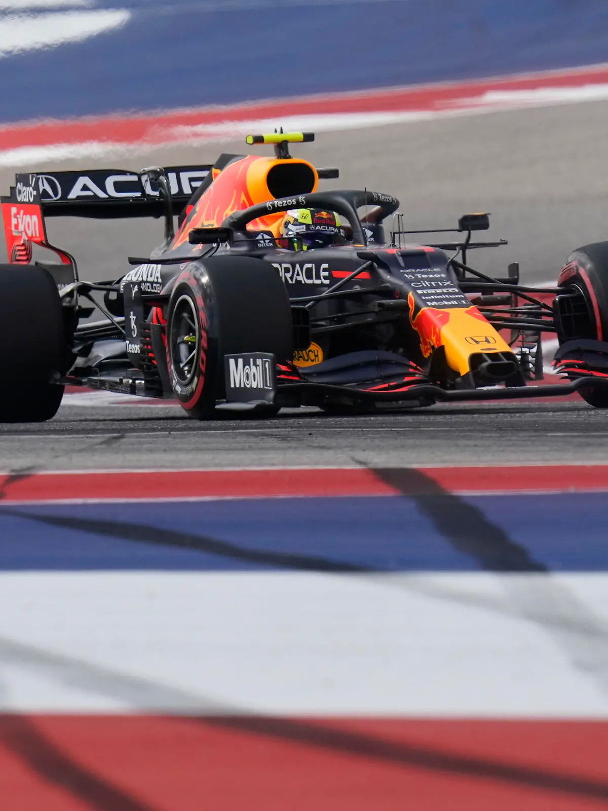 Red Bull driver Sergio Perez, of Mexico, steers through a turn during an open practice for the Formula One U.S. Grand Prix auto race at the Circuit of the Americas, Friday, Oct. 22, 2021, in Austin, Texas. (AP Photo/Eric Gay)