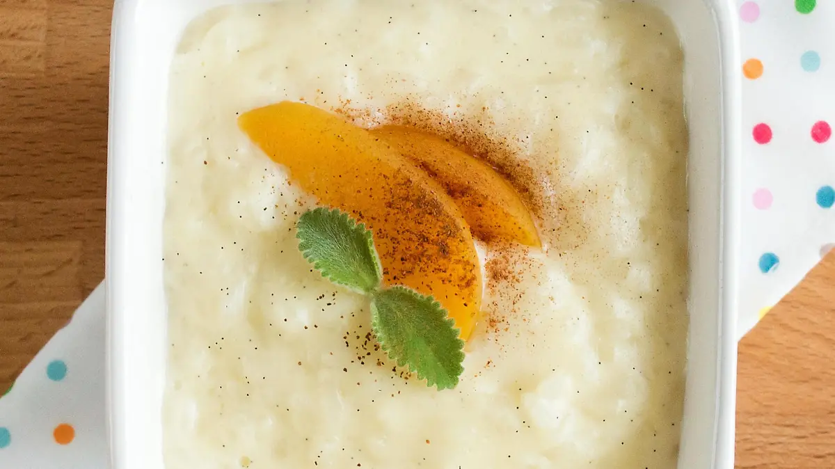 Rice pudding in a square white plate. Dessert serving, top.