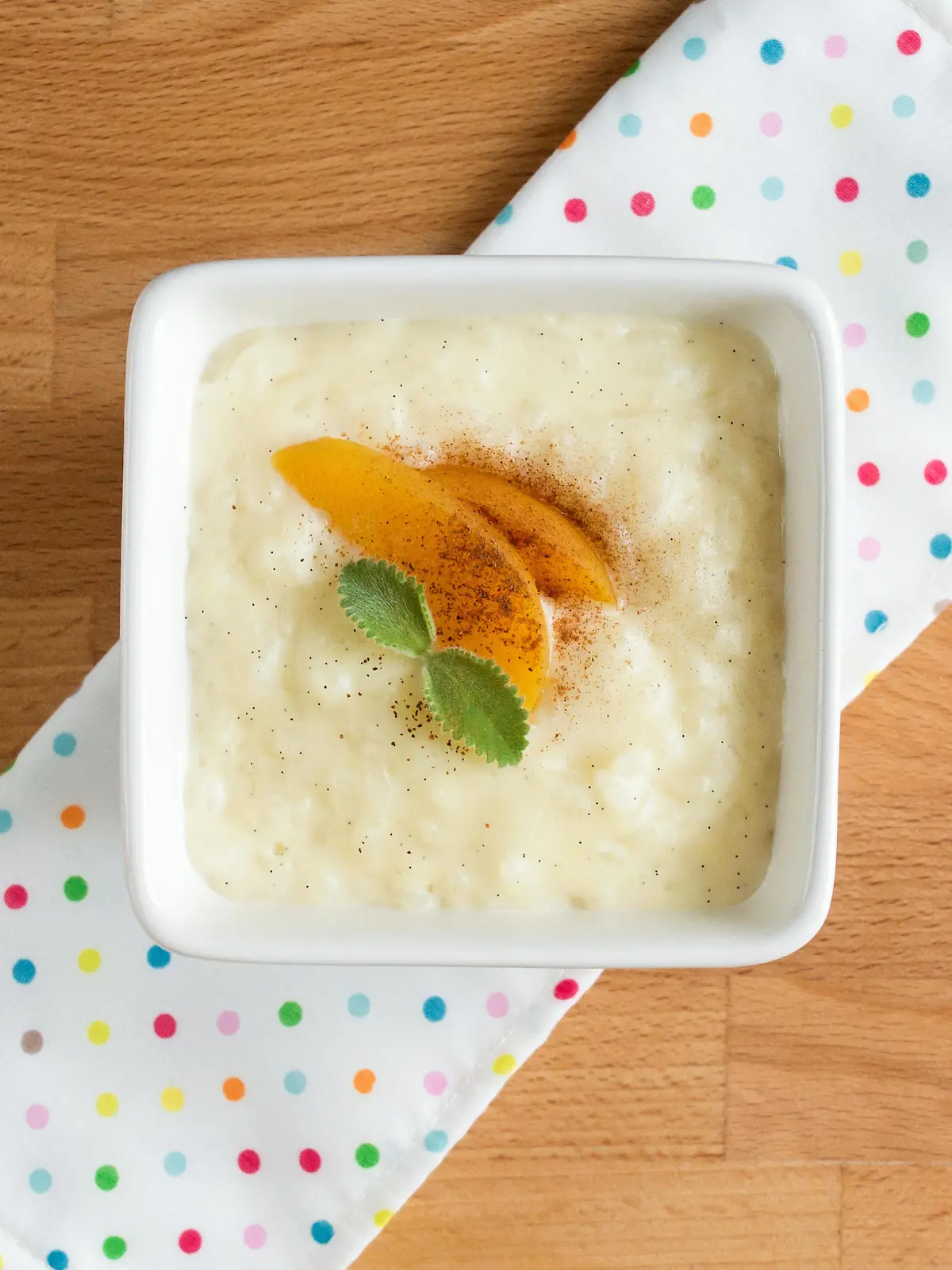Rice pudding in a square white plate. Dessert serving, top.