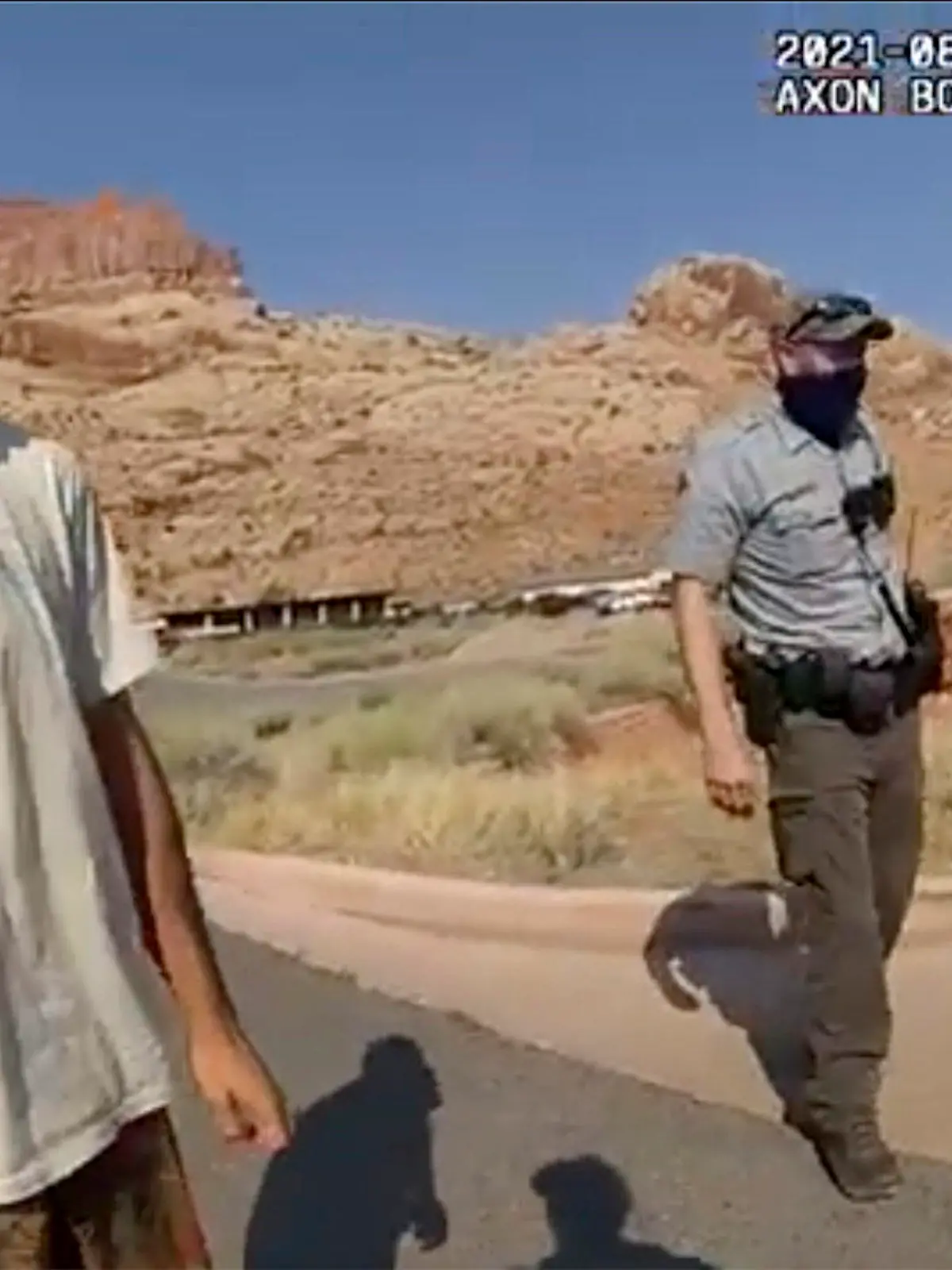 FILE - This Aug. 12, 2021 file photo from video provided by The Moab Police Department shows Brian Laundrie talking to a police officer after police pulled over the van he was traveling in with his girlfriend, Gabrielle "Gabby" Petito, near the entrance to Arches National Park. Laundrie, the boyfriend of Gabby Petito, whose body was found at a national park in Wyoming after a cross-country trip with him, has been charged with unauthorized use of a debit card as searchers continue looking for him in Florida swampland, federal authorities announced Thursday, Sept. 23, 2021. (The Moab Police Department via AP, File)