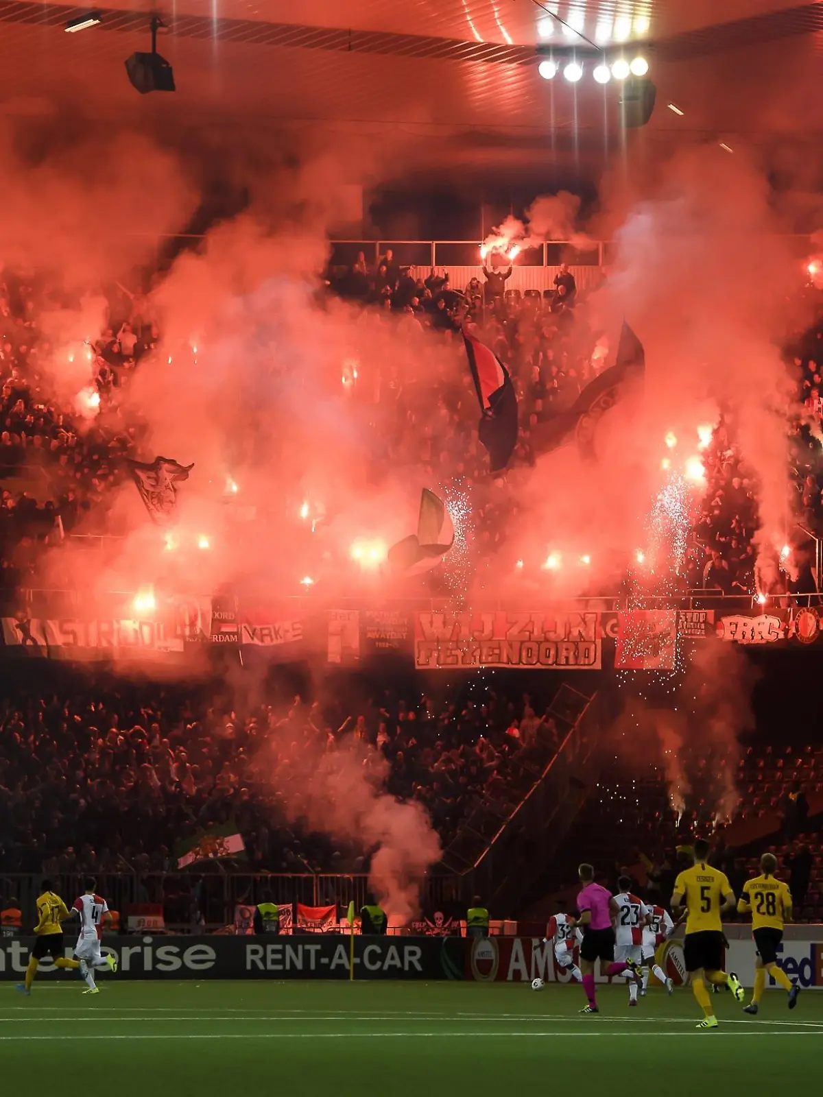 Fans of Feyernoord Rotterdam pictured with pyrotechnic devices, during the UEFA Europa League group stage group G soccer match between Switzerland's BSC Young Boys Bern and Nederland's Feyernoord Rotterdam, at the Stade de Suisse in Bern, Switzerland, Thursday, October 24, 2019. (KEYSTONE/Anthony Anex)