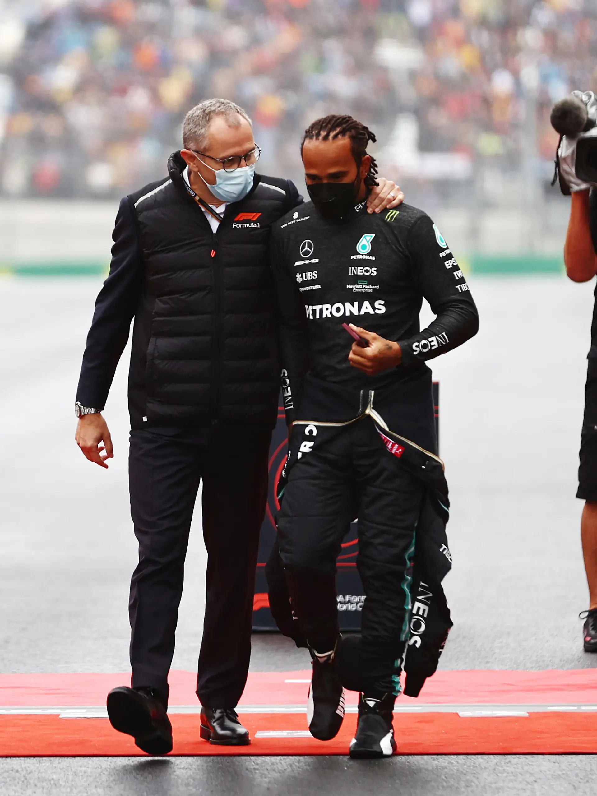 ISTANBUL, TURKEY - OCTOBER 10: Lewis Hamilton of Great Britain and Mercedes GP talks with Stefano Domenicali, CEO of the Formula One Group, on the grid during the F1 Grand Prix of Turkey at Intercity Istanbul Park on October 10, 2021 in Istanbul, Turkey. (Photo by Mark Thompson/Getty Images)