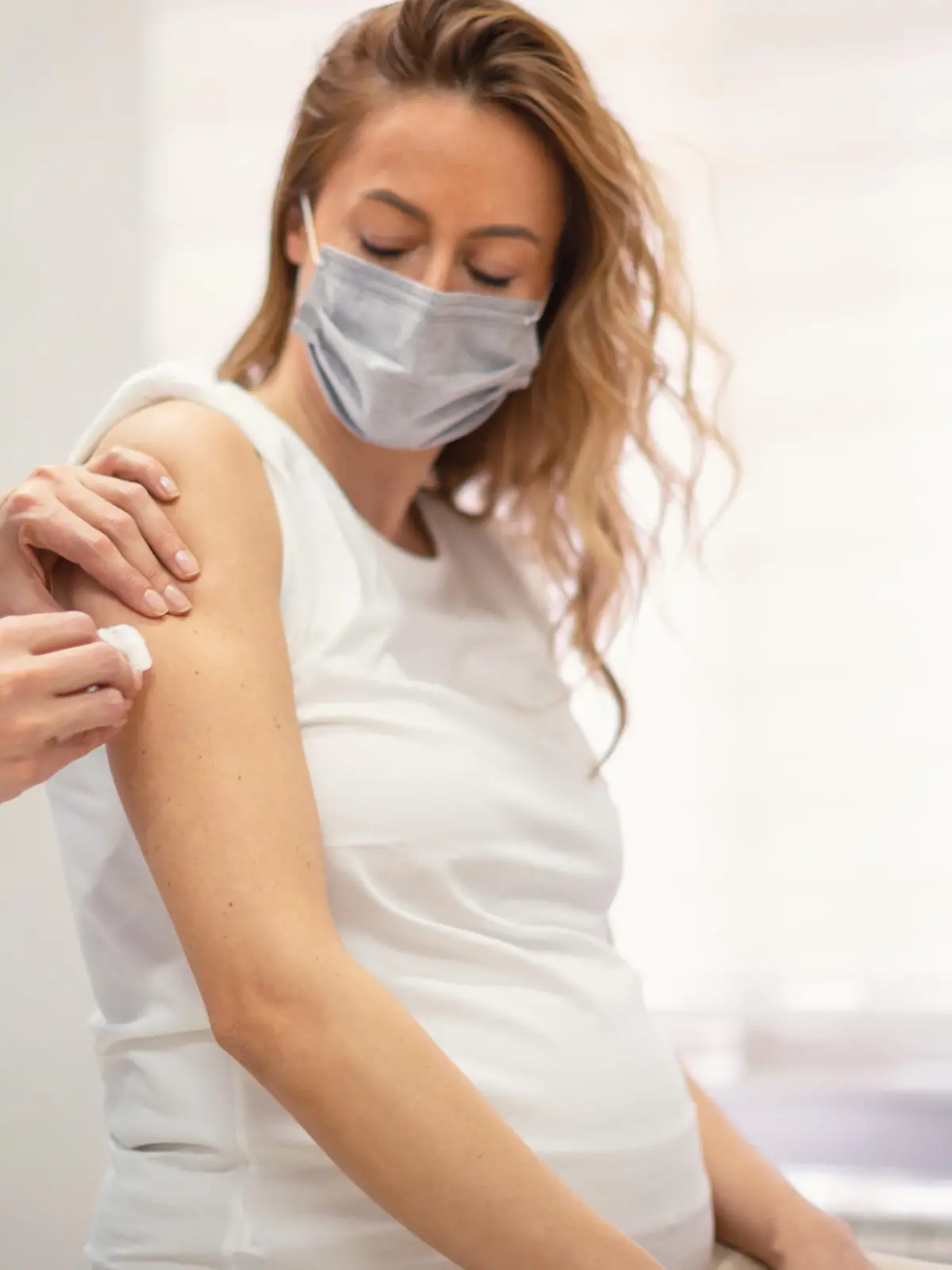 Applying a COVID-19 vaccine to a pregnant woman