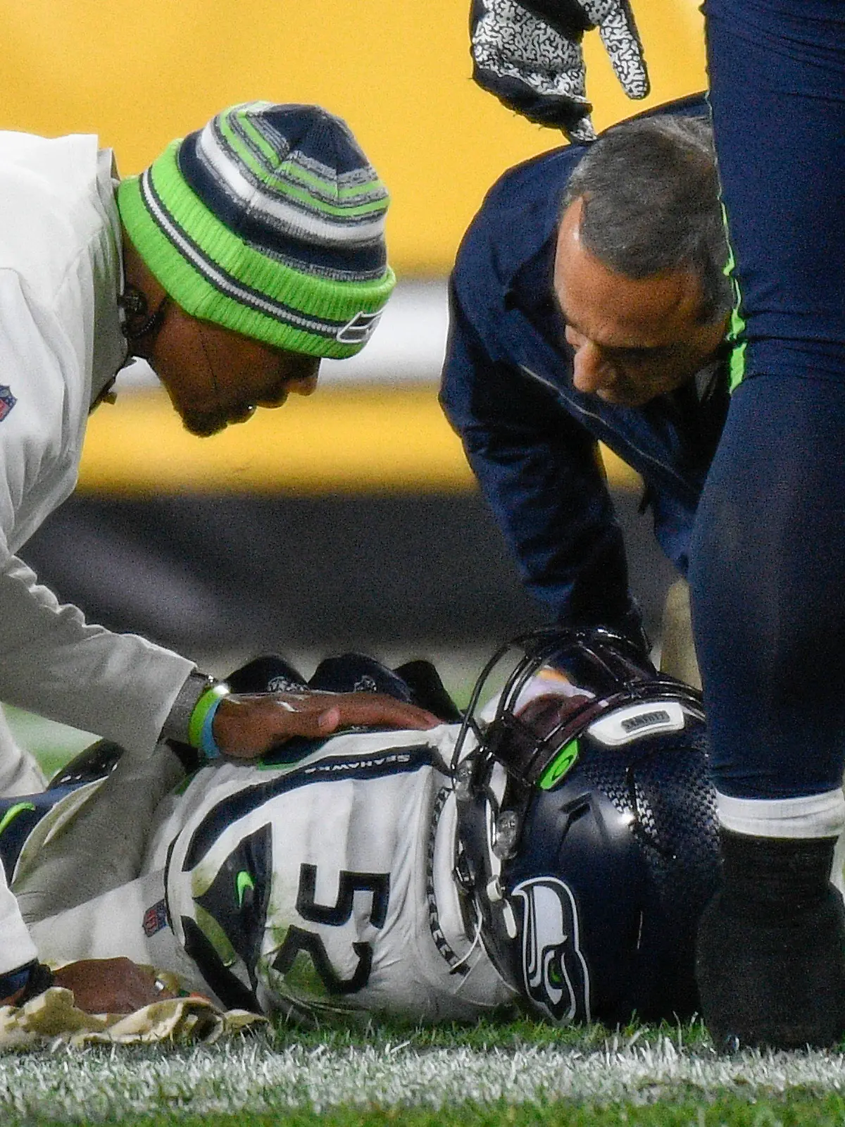 Seattle Seahawks defensive end Darrell Taylor (52) lays on the ground and is tended after being injured during the second half an NFL football game against the Pittsburgh Steelers, Sunday, Oct. 17, 2021, in Pittsburgh. (AP Photo/Don Wright)