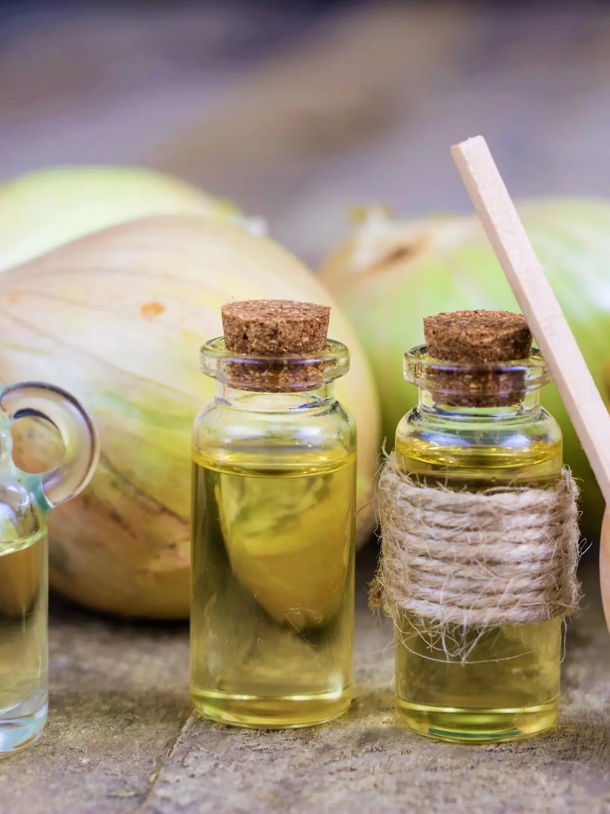 Onion juice and vegetables on a wooden table. Home-made syrup for the treatment of influenza. Dark background.