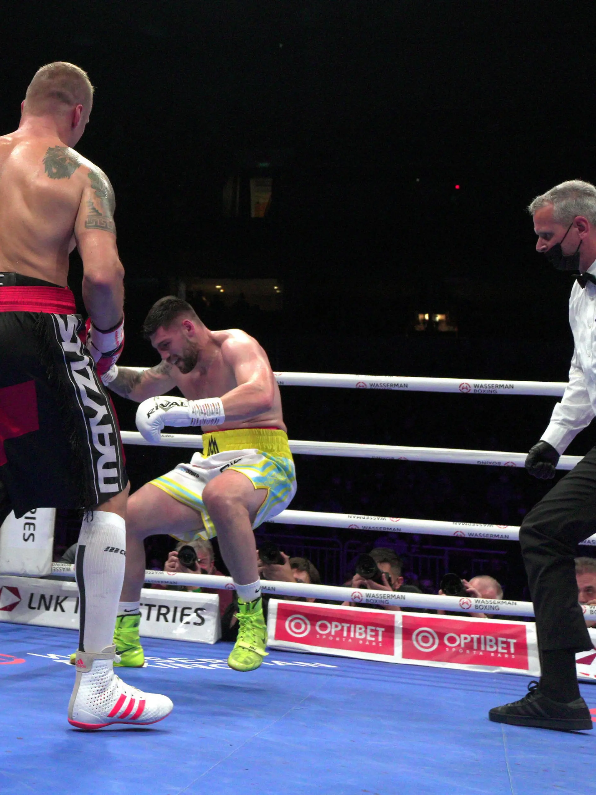  211017 -- LATVIA, Oct. 17, 2021 -- Mairis Briedis L of Latvia knocks down Artur Mann C of Germany during the cruiserweight IBF World Champion title boxing match at the Arena Riga, in Riga, Latvia, Oct. 16, 2021. Photo by /Xinhua SPLATVIA-RIGA-BOXING-IBF-CRUISERWEIGHT TITLE FIGHT EdijsxPalens PUBLICATIONxNOTxINxCHN
