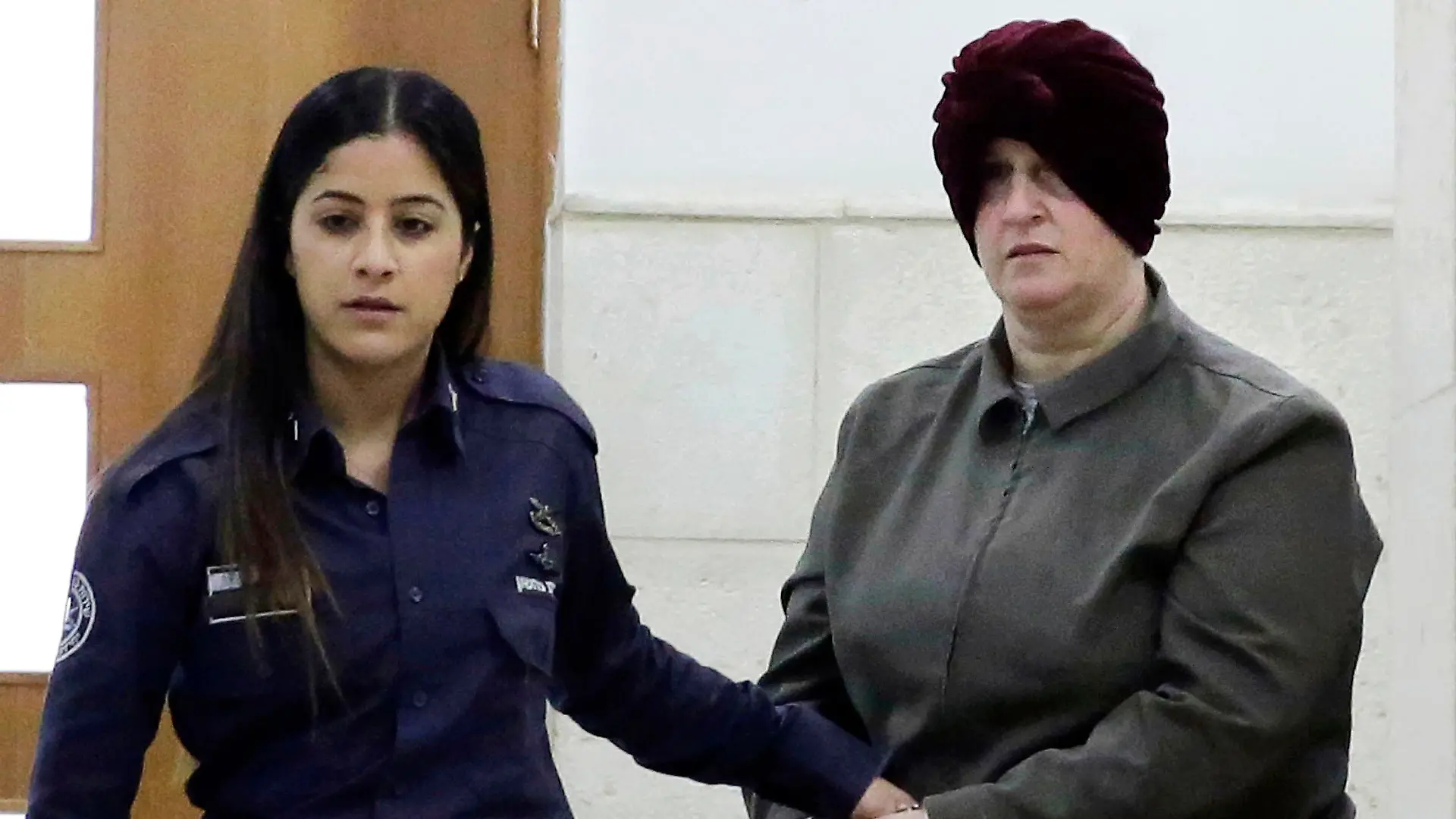 FILE - Israeli-born Australian Malka Leifer, right, is brought to a courtroom in Jerusalem on Feb. 27, 2018. Leifer, a former principal of an Australian Jewish school, was sentenced on Thursday, Aug. 24, 2023, to 15 years in prison after she was convicted of sexually abusing two students. (AP Photo/Mahmoud Illean, File)