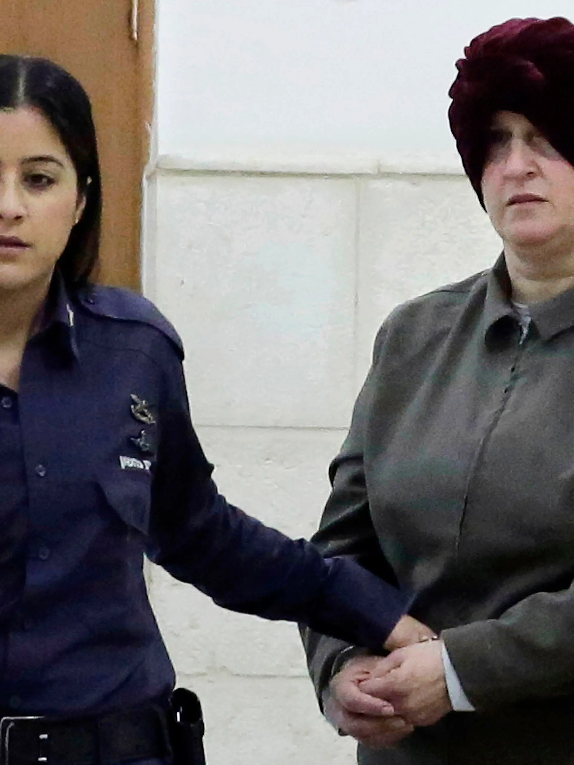 FILE - Israeli-born Australian Malka Leifer, right, is brought to a courtroom in Jerusalem on Feb. 27, 2018. Leifer, a former principal of an Australian Jewish school, was sentenced on Thursday, Aug. 24, 2023, to 15 years in prison after she was convicted of sexually abusing two students. (AP Photo/Mahmoud Illean, File)
