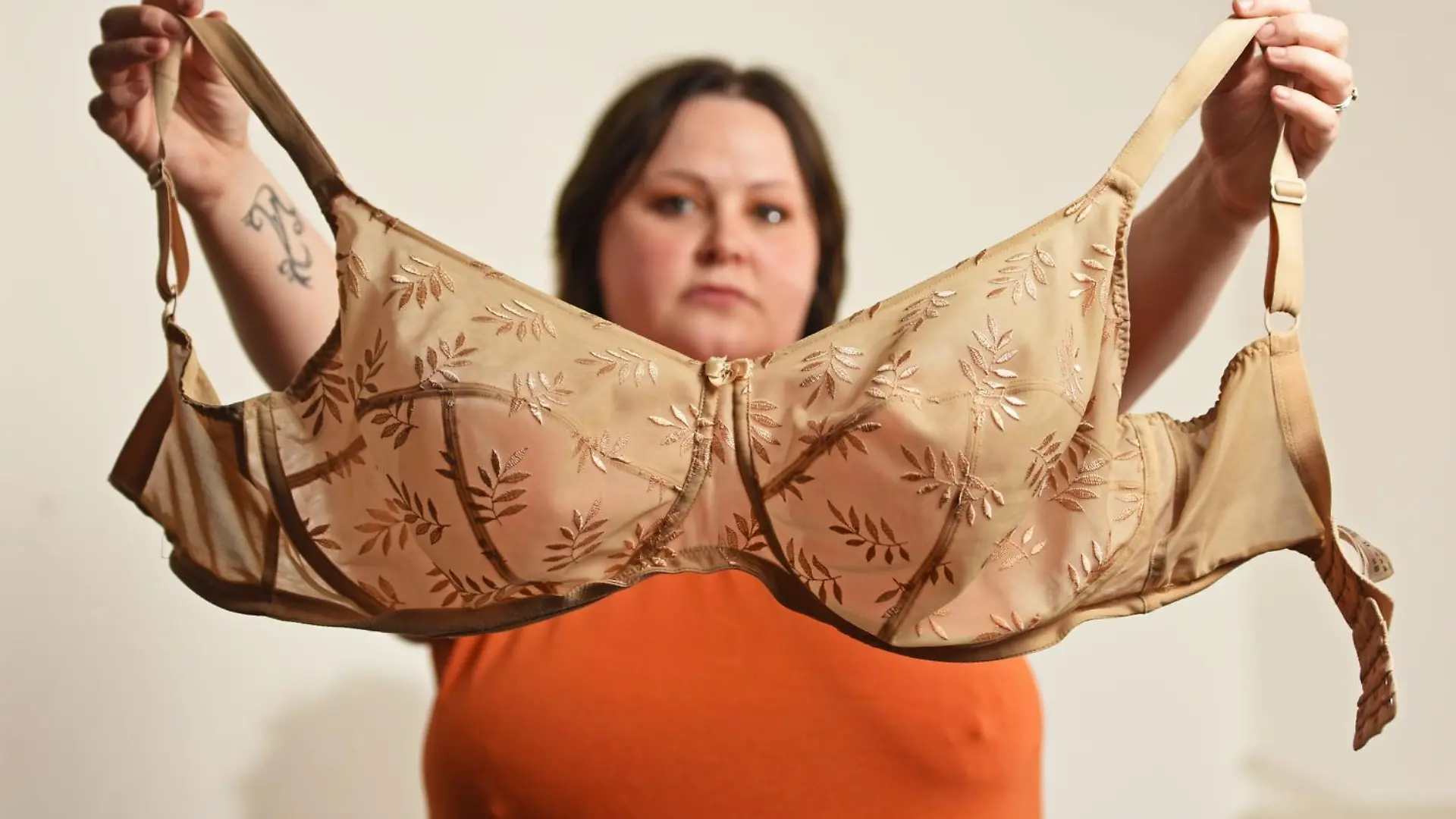 WILLIAM LAILEY / CATERS NEWS (PICTURED- Elizabeth Catlin holding up the one and only bra she owns) - A mum with ever-growing 34JJ breasts has stated that she couldn't even breastfeed her own daughter in fear she'd suffocate her. Elizabeth Catlin, from Swadlincote, Derbs, says that since the age of 10 her boobs haven't stopped growing. She says this meant that she couldn't even breastfeed her daughter, Willow, now two, as they would have covered her face and suffocated her. The 32-year-old is now a JJ in cup size and desperate for breast reduction surgery because she hates her boobs so much. - SEE CATERS COPY