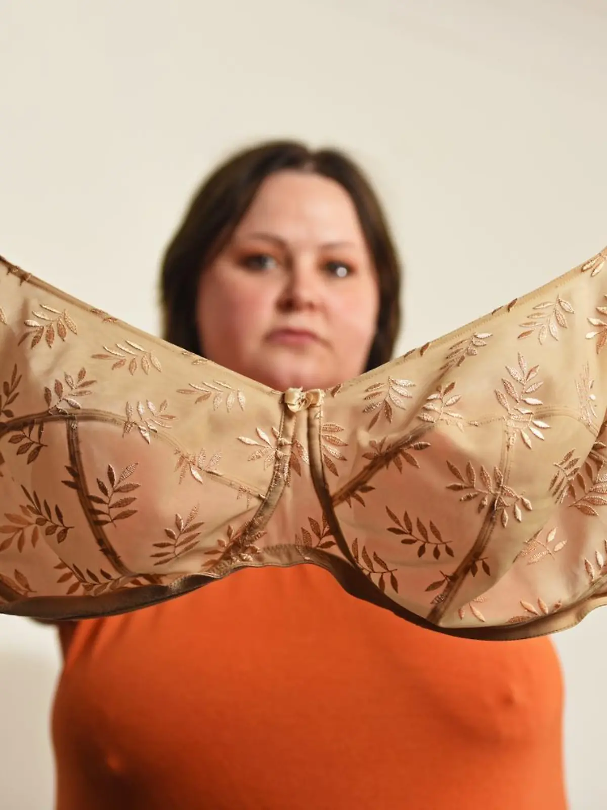 WILLIAM LAILEY / CATERS NEWS (PICTURED- Elizabeth Catlin holding up the one and only bra she owns) - A mum with ever-growing 34JJ breasts has stated that she couldn't even breastfeed her own daughter in fear she'd suffocate her. Elizabeth Catlin, from Swadlincote, Derbs, says that since the age of 10 her boobs haven't stopped growing. She says this meant that she couldn't even breastfeed her daughter, Willow, now two, as they would have covered her face and suffocated her. The 32-year-old is now a JJ in cup size and desperate for breast reduction surgery because she hates her boobs so much. - SEE CATERS COPY