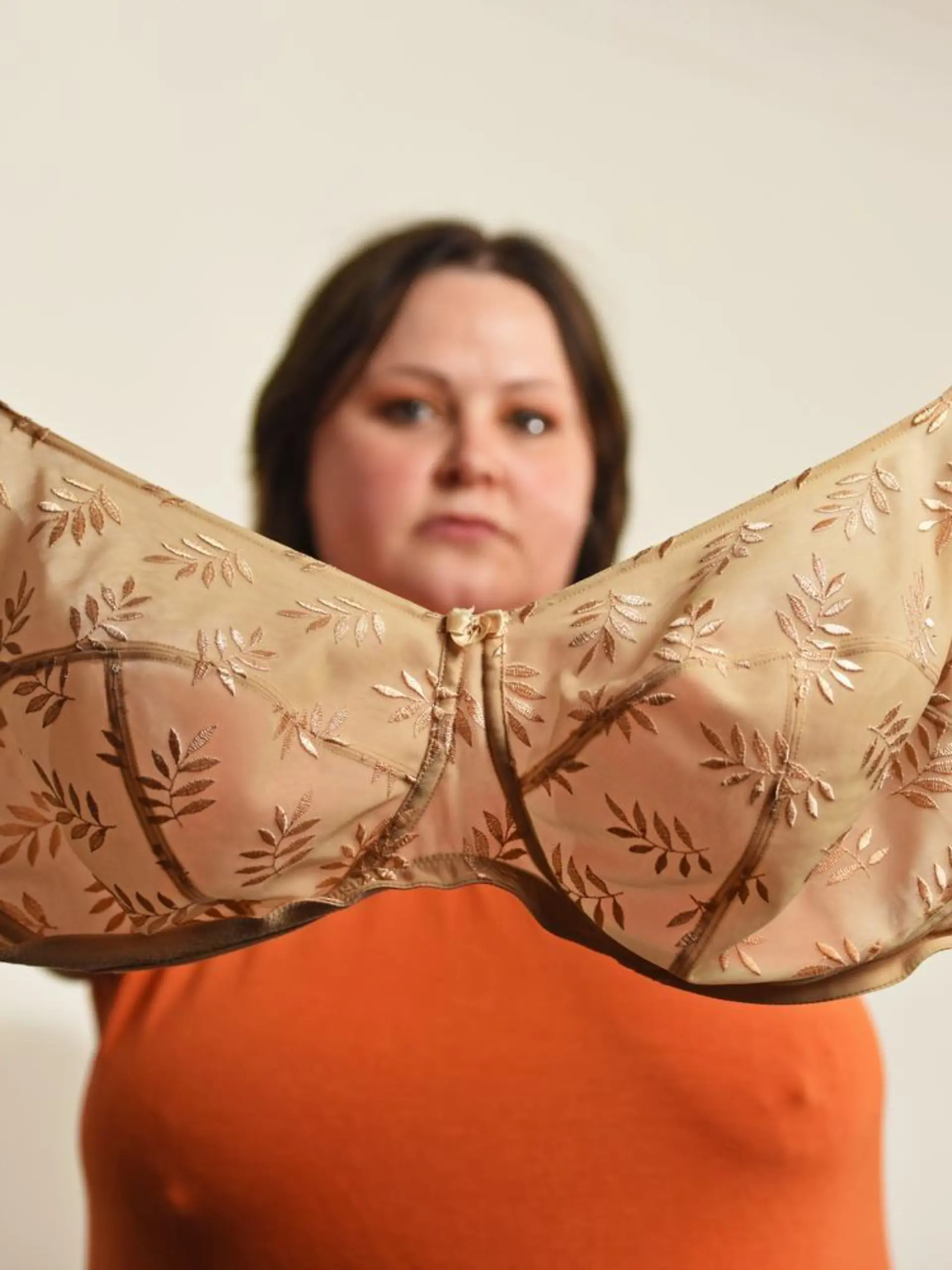 WILLIAM LAILEY / CATERS NEWS (PICTURED- Elizabeth Catlin holding up the one and only bra she owns) - A mum with ever-growing 34JJ breasts has stated that she couldn't even breastfeed her own daughter in fear she'd suffocate her. Elizabeth Catlin, from Swadlincote, Derbs, says that since the age of 10 her boobs haven't stopped growing. She says this meant that she couldn't even breastfeed her daughter, Willow, now two, as they would have covered her face and suffocated her. The 32-year-old is now a JJ in cup size and desperate for breast reduction surgery because she hates her boobs so much. - SEE CATERS COPY