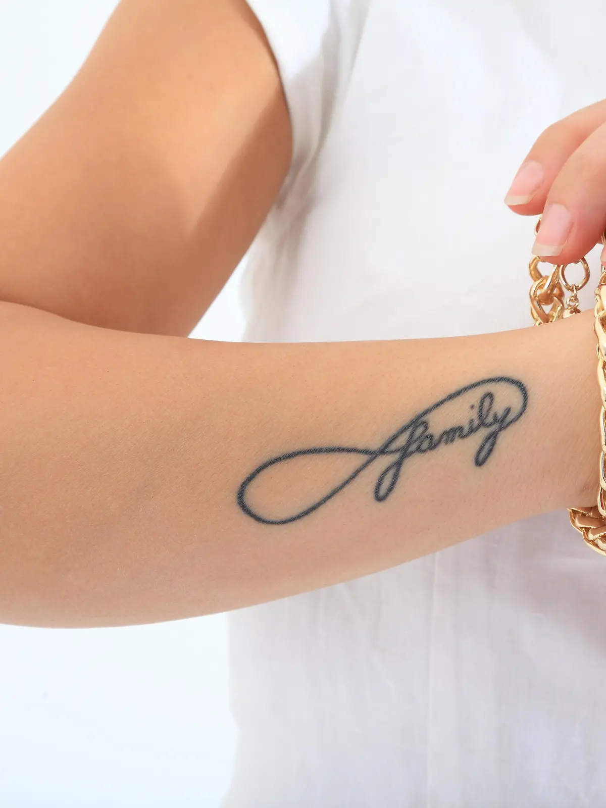 the word family on a woman's arm tattooed