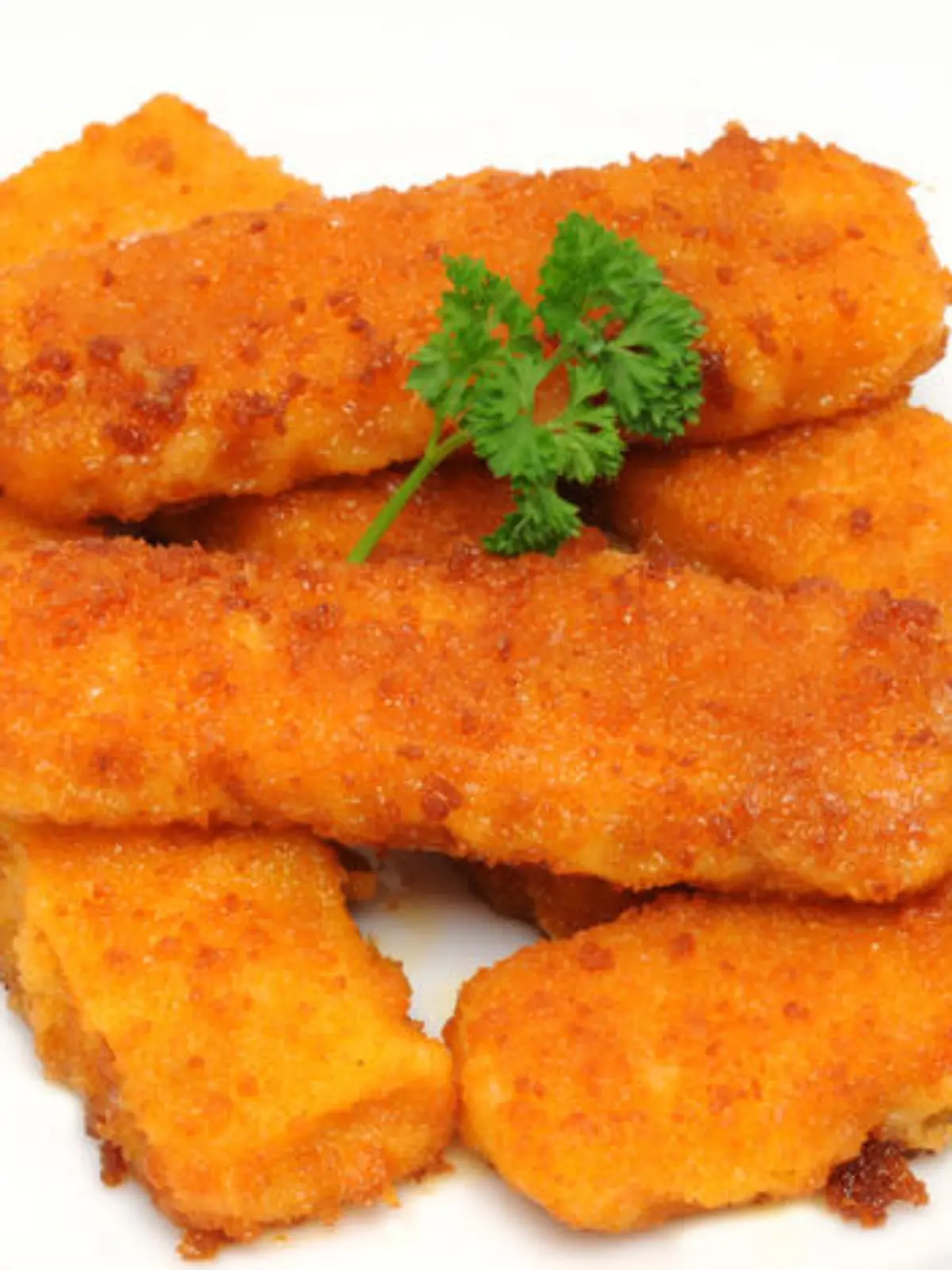 Fischstabchen in heissem Fett in der Bratpfanne / Fish fingers in a frying pan