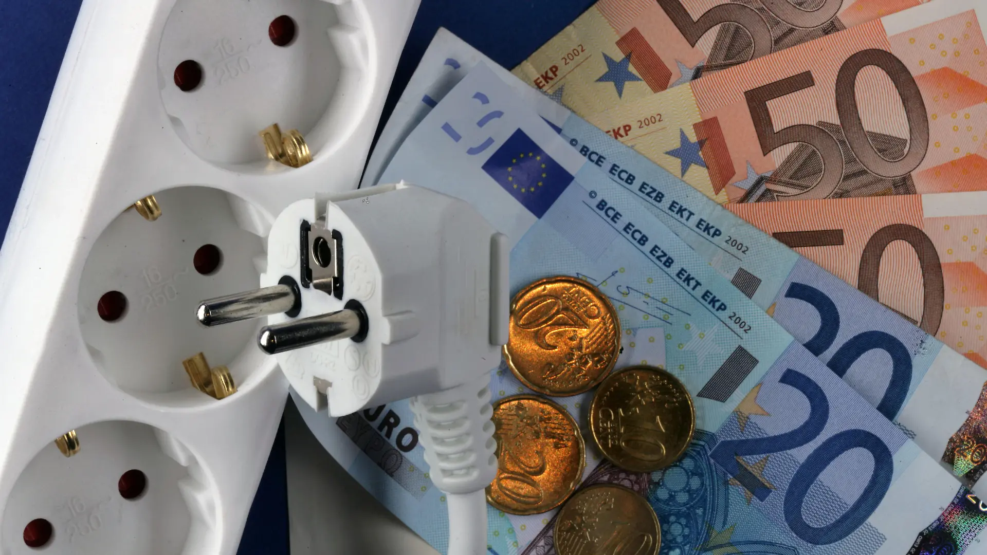 Euro-Geldscheine liegen neben einem Elektrostecker und einer Steckdosenleiste (Illustration zum Thema Strompreise), aufgenommen am 04.10.2006 in Schwerin. Der Strom-Preis für eine Kilowattstunde ist in den vergangenen acht Jahren um 2,35 Cent gestiegen. Zugleich ist der Preis für Erzeugung, Transport und Vertrieb des Stroms um einen Cent gefallen. Dies hat die Bundesregierung kürzlich in einer Antwort auf eine kleine Anfrage der Linksfraktion mitgeteilt. Auf dem Energiegipfel am Montag (09.10.2006), bei dem Bundeskanzlerin Merkel mit den Branchenvertretern über internationale und europäische Aspekte der Energieversorgung sprechen will, könnte auch das Thema Strompreise eine Rolle spielen. Foto: Jens Büttner +++(c) dpa - Report+++