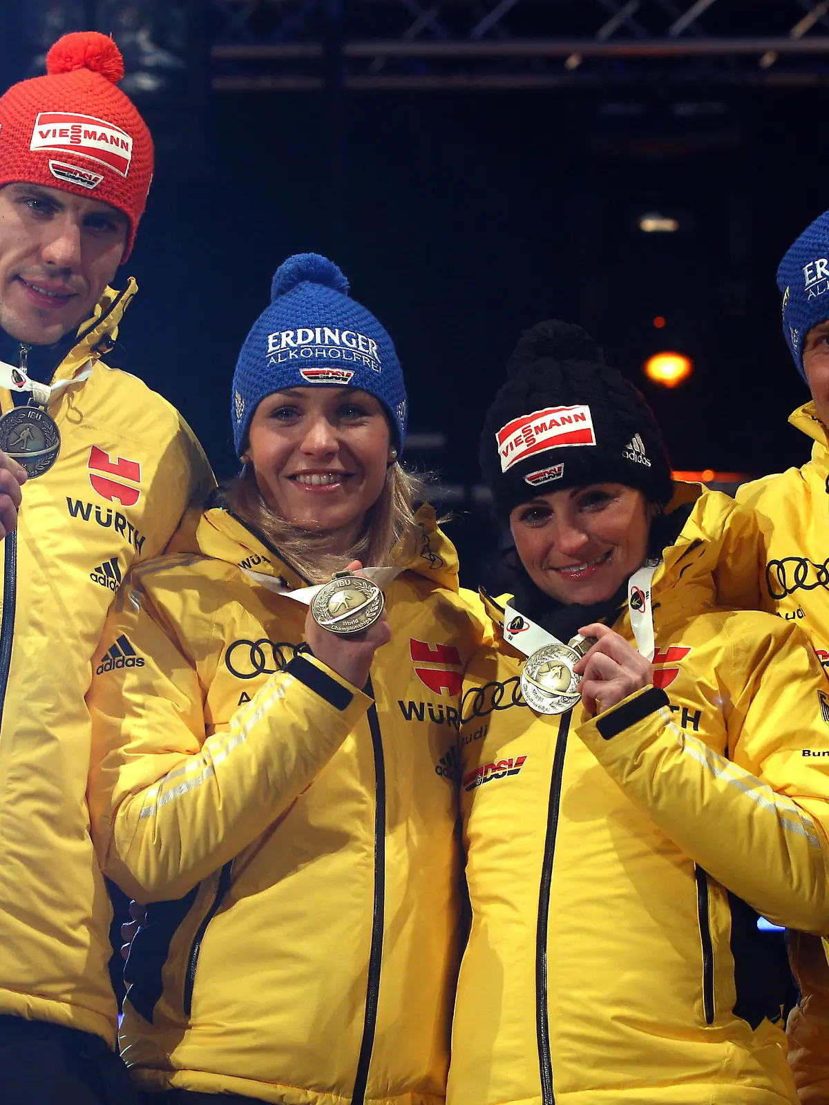 RUHPOLDING, GERMANY - MARCH 01: Arnd Peiffer (L) of Germany celebrates winning the Bronce medal with his team mates Magdalena Neuner (2nd L), Andrea Henkel (2nd R) and Andreas Birnbacher at the medal ceremony for the IBU Biathlon World Championships Mixed Relay on March 1, 2012 in Ruhpolding, Germany.  (Photo by Alexander Hassenstein/Bongarts/Getty Images)