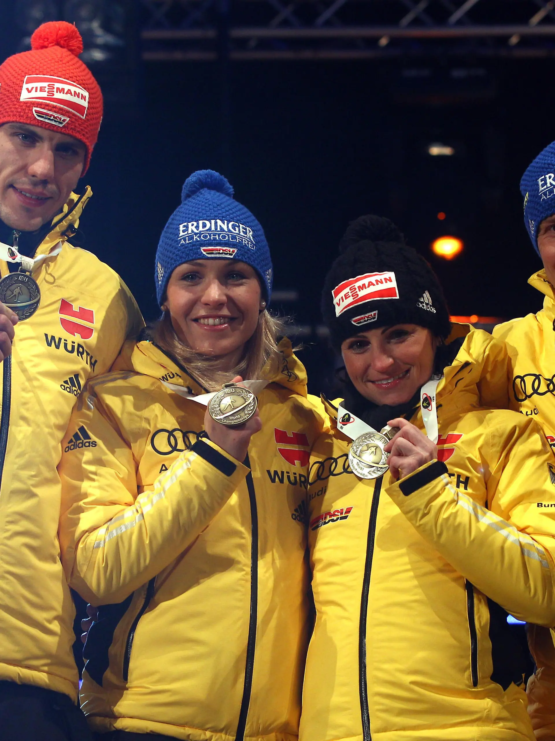 RUHPOLDING, GERMANY - MARCH 01: Arnd Peiffer (L) of Germany celebrates winning the Bronce medal with his team mates Magdalena Neuner (2nd L), Andrea Henkel (2nd R) and Andreas Birnbacher at the medal ceremony for the IBU Biathlon World Championships Mixed Relay on March 1, 2012 in Ruhpolding, Germany.  (Photo by Alexander Hassenstein/Bongarts/Getty Images)