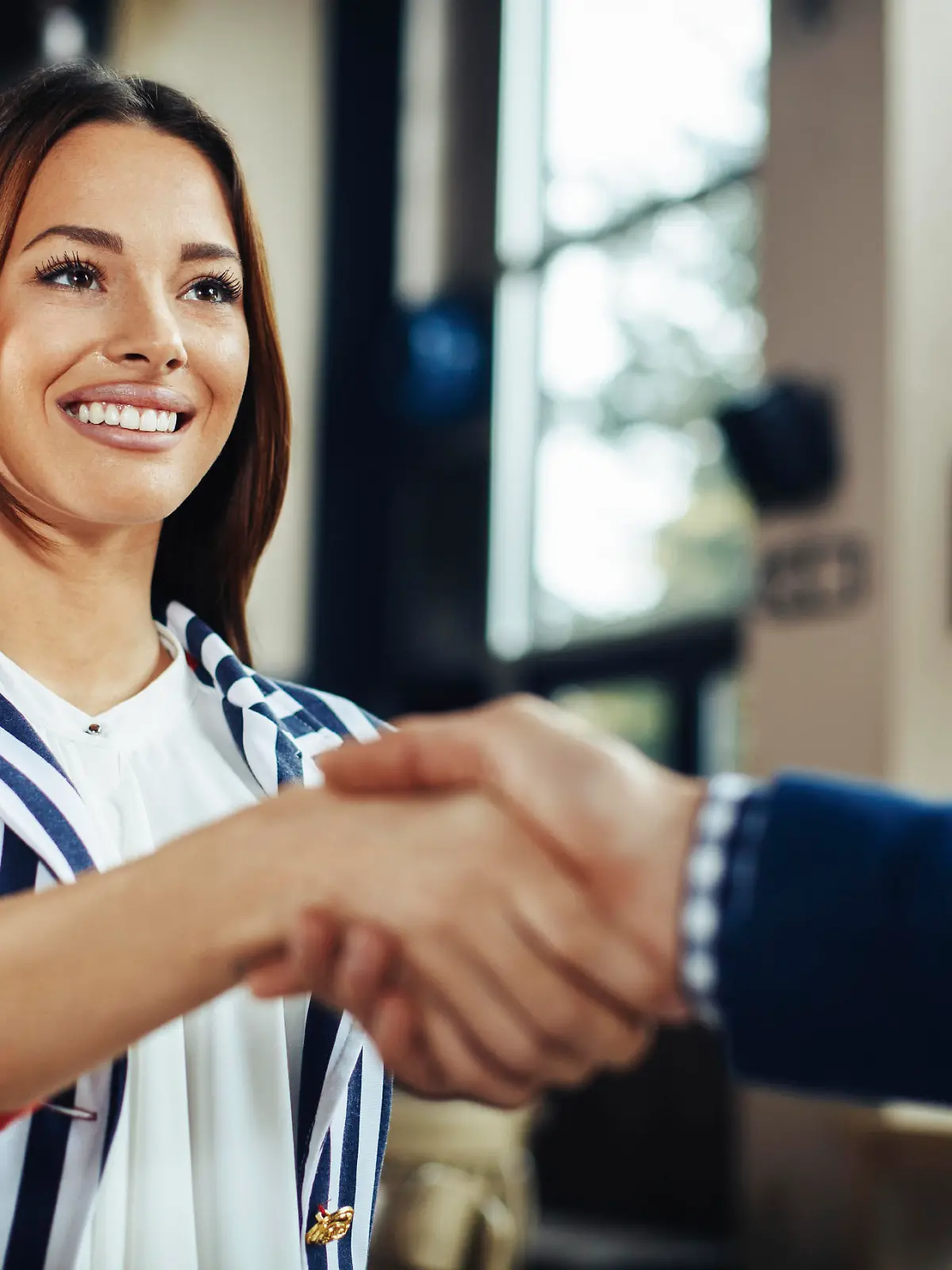 Businesswoman and businessman handshake in the cafe