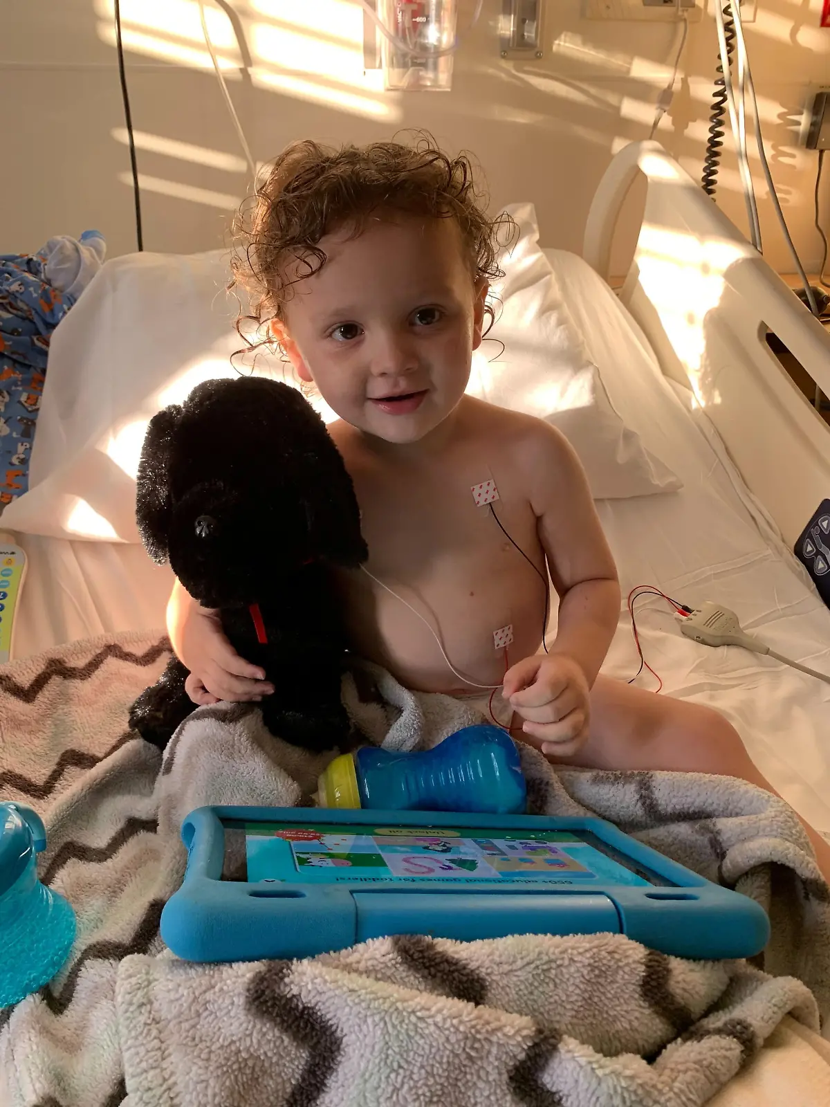Adrian James, 2, sits up in a bed after spending more than a week on a ventilator in the intensive care unit at Cardinal Glennon Children's Hospital in St. Louis for a severe case of COVID-19, in Missouri, U.S., October 11, 2021. Tiffany Jackson/Handout via REUTERS. THIS IMAGE HAS BEEN SUPPLIED BY A THIRD PARTY. NO RESALES. NO ARCHIVES