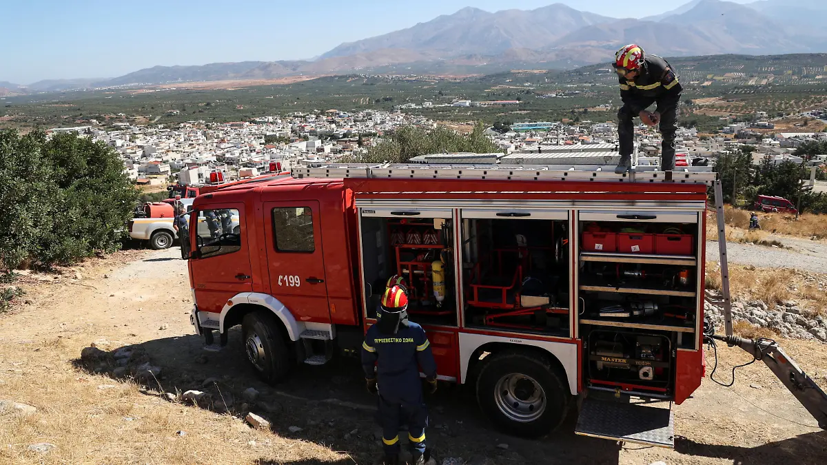 A firefighter stands on top of a fire engine following an earthquake, in the town of Arkalochori on the island of Crete, Greece, September 27, 2021. REUTERS/Stefanos Rapanis