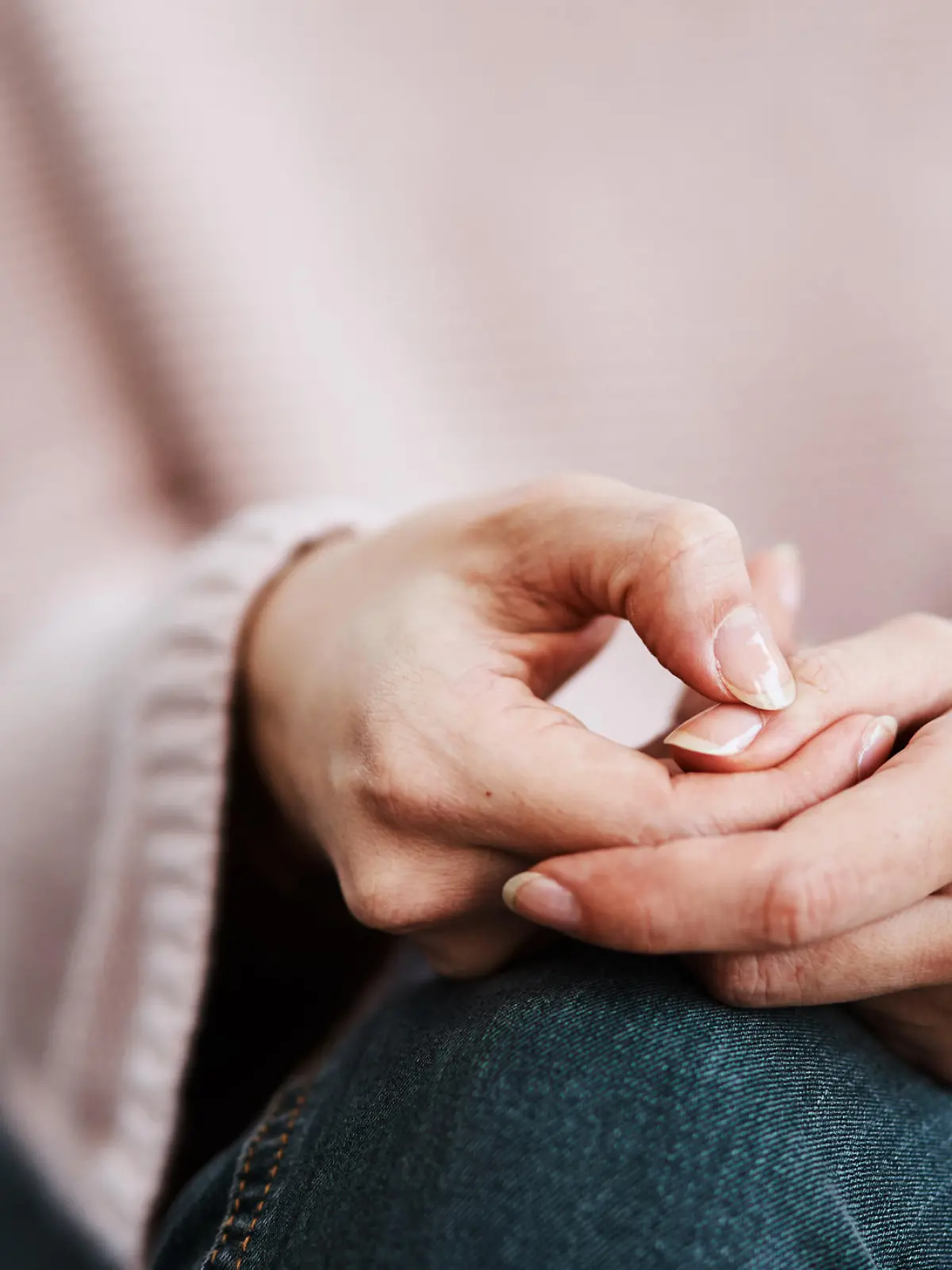 Cropped shot of a woman sitting on a sofa and feeling anxious