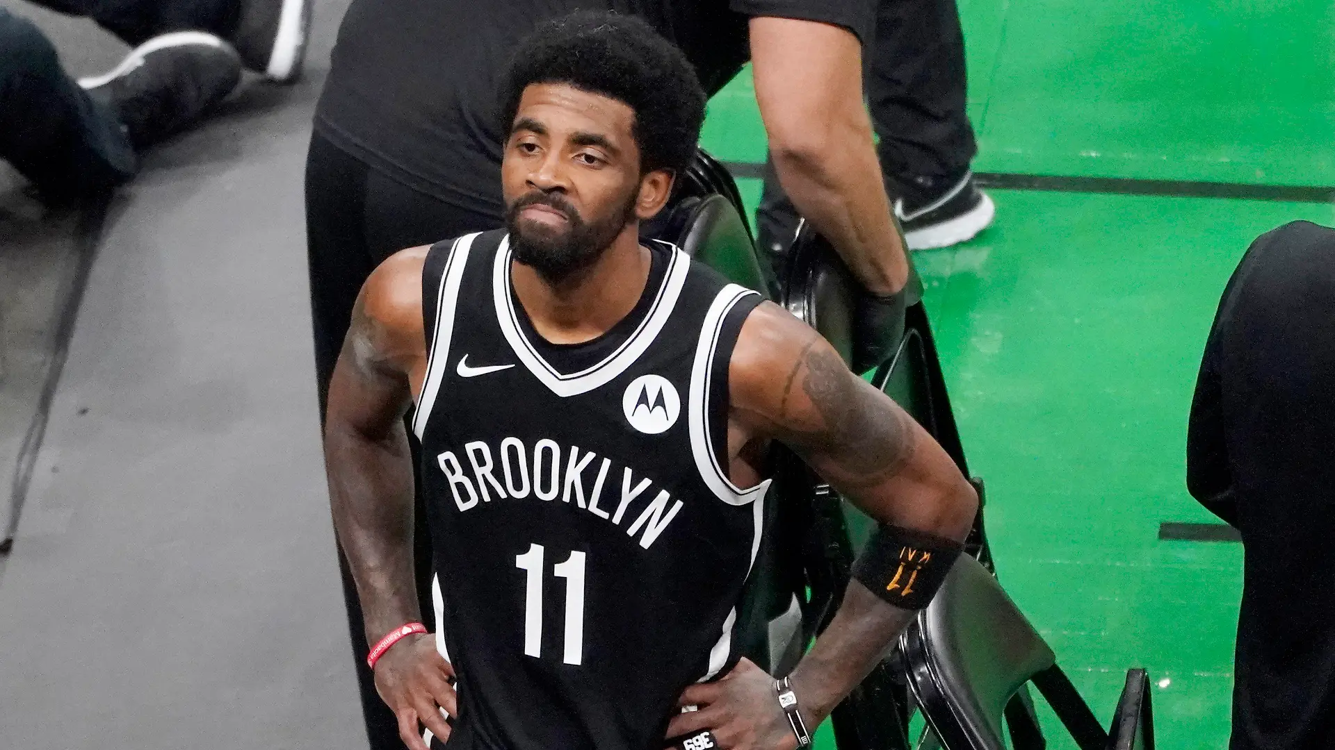 FILE - Brooklyn Nets guard Kyrie Irving looks up at the fans at TD Garden after they defeated the Boston Celtics in Game 4 during an NBA basketball first-round playoff series in Boston, in this Sunday, May 30, 2021, file photo. The Brooklyn Nets won't play Kyrie Irving until he can play in all their games, unwilling to let questions about his vaccination status linger into the season. The Nets announced Tuesday, Oct. 12, 2021, that Irving would not play or practice with them until he could be a full participant, ending the idea that he would play in only road games. Without mentioning his vaccination status, general manager Sean Marks said Irving has made a decision that keeps him from being able to perform with the team. (AP Photo/Elise Amendola, File)