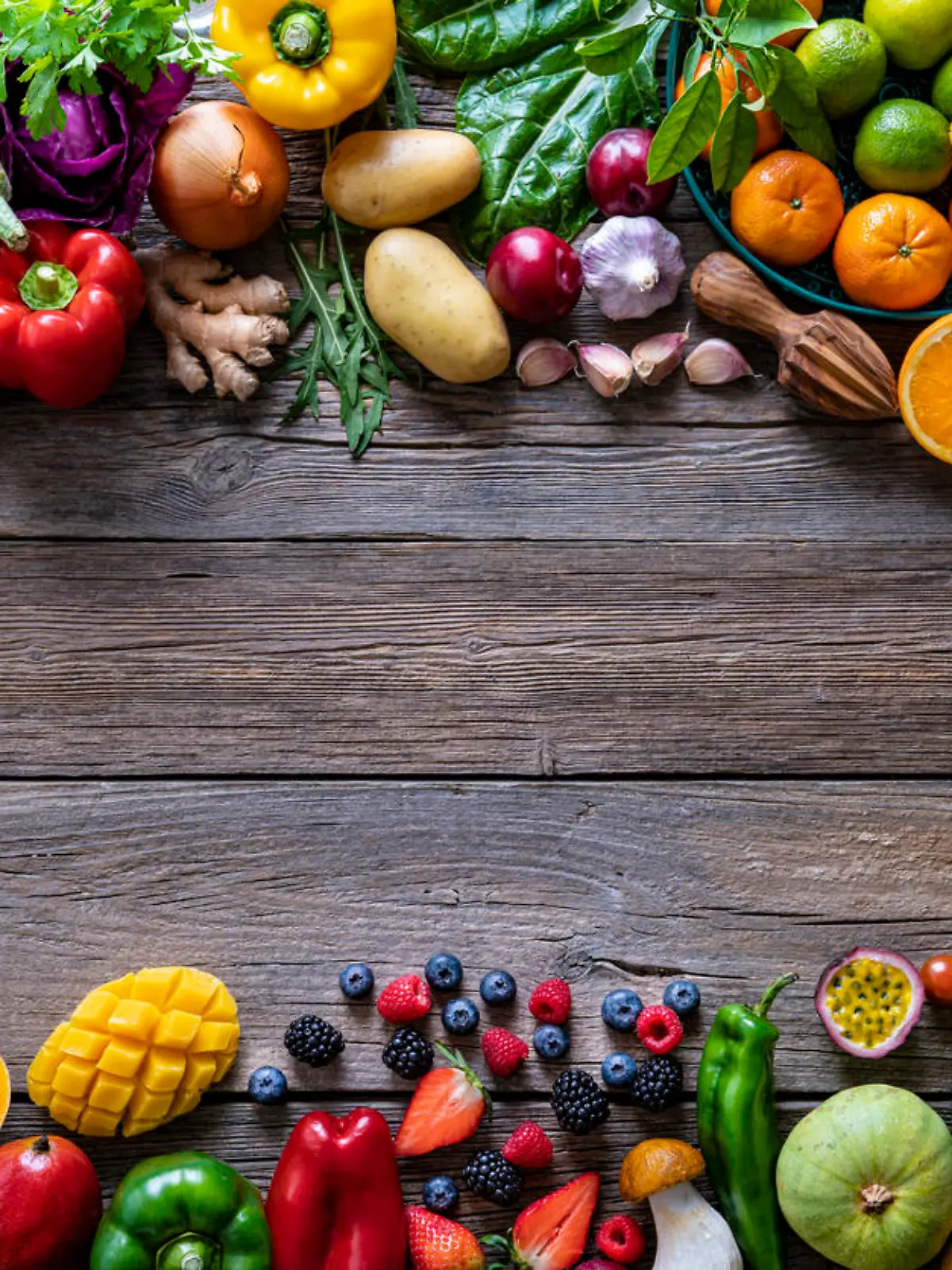 Vegetables and fruits vegan food assorted arrangement varied leaving rustic wood copy space background